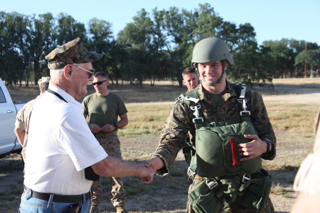 Marine World War II Veteran, Bill Darling, shakes hands with Lance Cpl. Mark Adams with 4th Force Reconnaissance Company, 4th Marine Division during their drill weekend at Fort Hunter Liggett, California, May 02, 2015. The retired Sgt. Bill Darling served with 3rd Battalion, 1st Marines Regiment during the Peleliu and Okinawa campaigns. Darling enlisted in 1943 and served until 1945. Five years later he was called to serve during the Korean War in 1950 and retired in 1951. (Photo courtesy of 4th Force Reconnaissance Company)