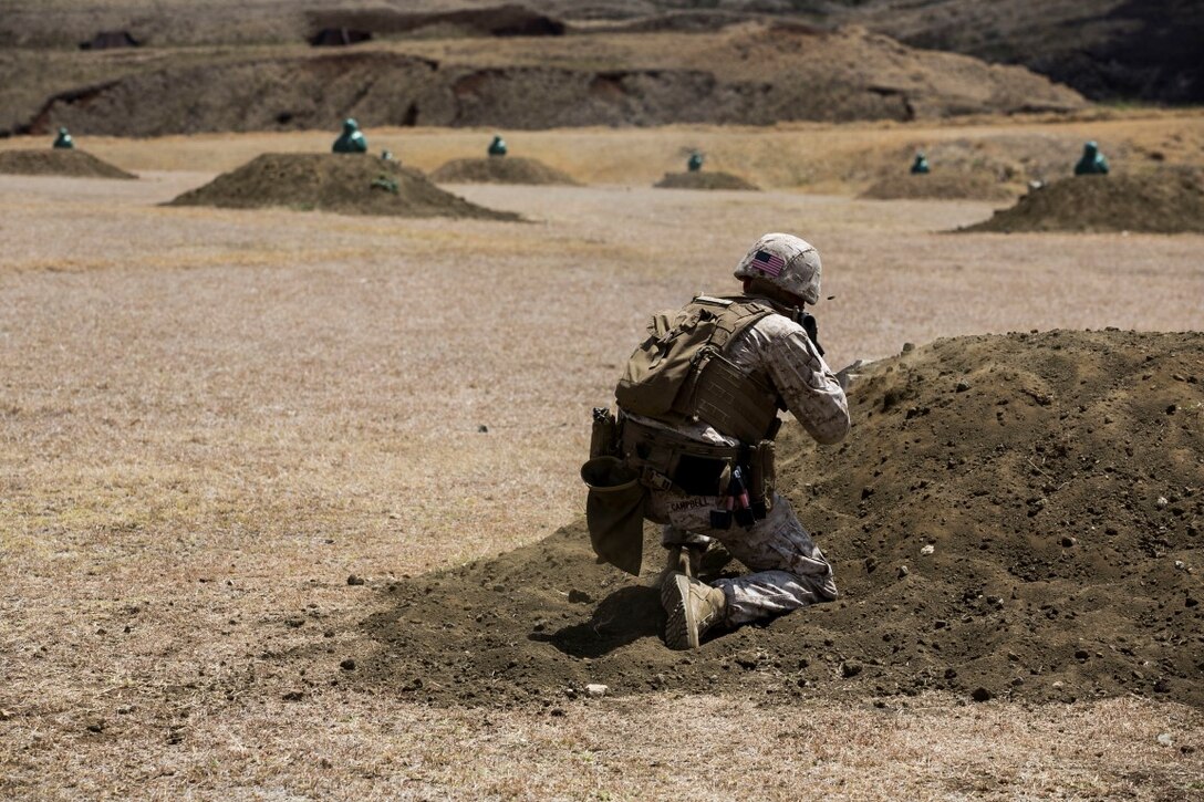 U.S. Marine Cpl. Brandon Campbell engages his target on an unknown distance range aboard Marine Corps Base Hawaii, May 11, 2015. Campbell is a squad leader with the 15th Marine Expeditionary Unit’s Maritime Raid Force Security Element. The MRF is keeping their skills sharp after recently completing the 15th MEU’s certification exercise (CERTEX) and leaving for deployment to the 5th and 7th Fleet areas of responsibility. (U.S. Marine Corps photo by Cpl. Anna Albrecht/Released)