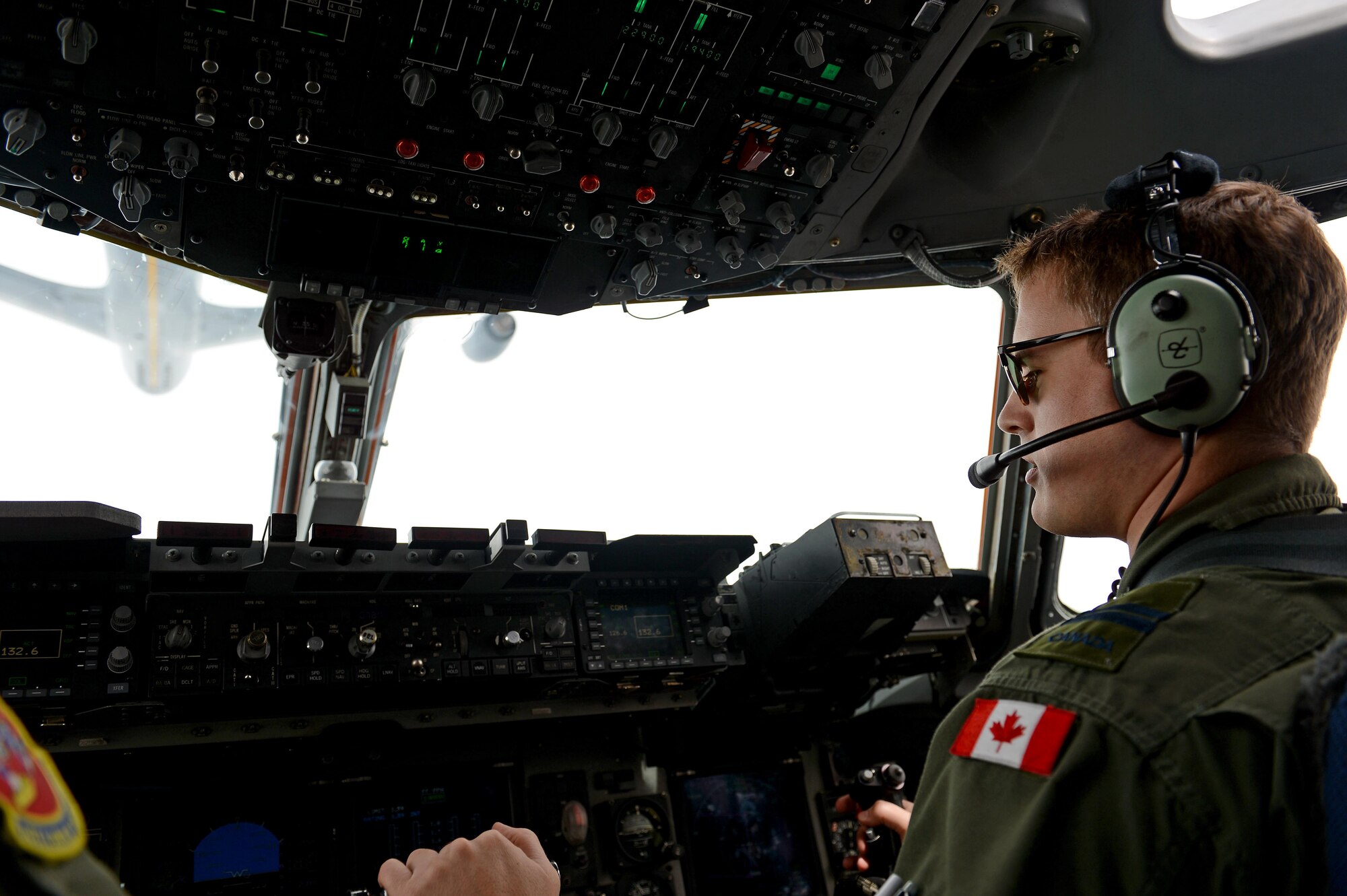 Royal Canadian Air Force Capt. Trevor Lanoue, a 10th Airlift Squadron C-17 Globemaster III pilot, conducts aerial refueling operations May 12, 2015, over central Washington state. Lanoue is part of the military exchange program working with the U.S. Air Force for a three year tour. (U.S. Air Force photo/Airman 1st Class Keoni Chavarria)