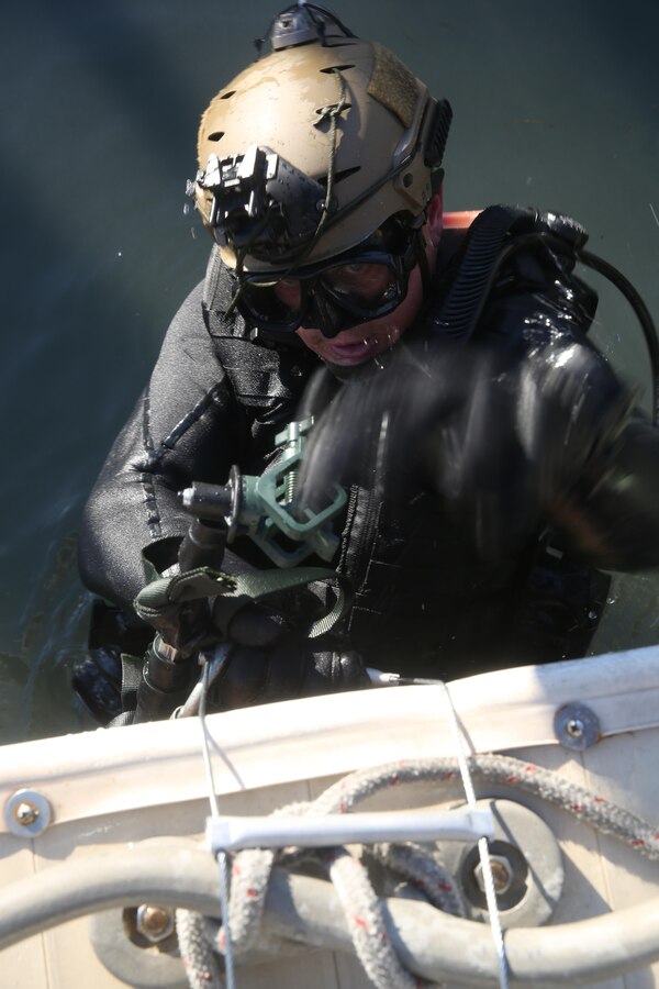 A critical skills operator with 1st Marine Special Operations Battalion climbs a collapsible ladder during a combat dive exercise, Feb. 21, 2015, in Key West, Fla. The operator’s team spent a week in Key West practicing various maritime operations skill sets, further solidifying the development of their techniques, tactics and procedures, and their standard operating procedures. (U.S. Marine Corps photo by Cpl. Steven Fox/Released)
