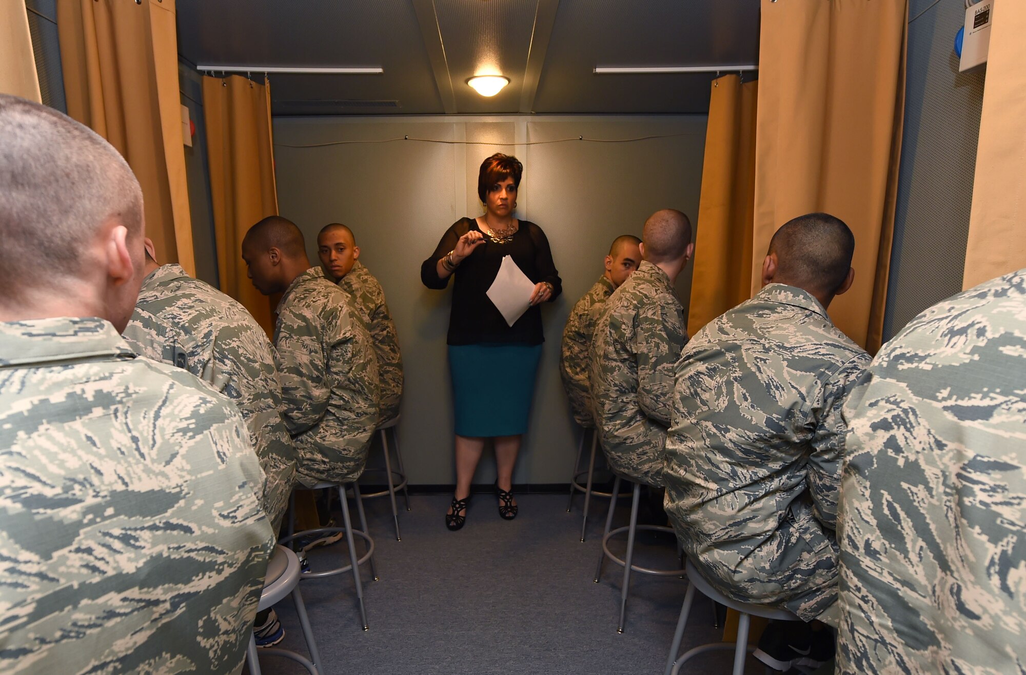 Carmen Puig-Martinez, audiology technician, instructs Basic Military Trainees of baseline hearing assessment procedures May 12, 2015, on Joint Base San Antonio-Lackland, Texas. The hearing assessment was created to provide an accurate hearing assessment of all recruits upon entering military service. (U.S. Air Force photo by Staff Sgt. Jerilyn Quintanilla)