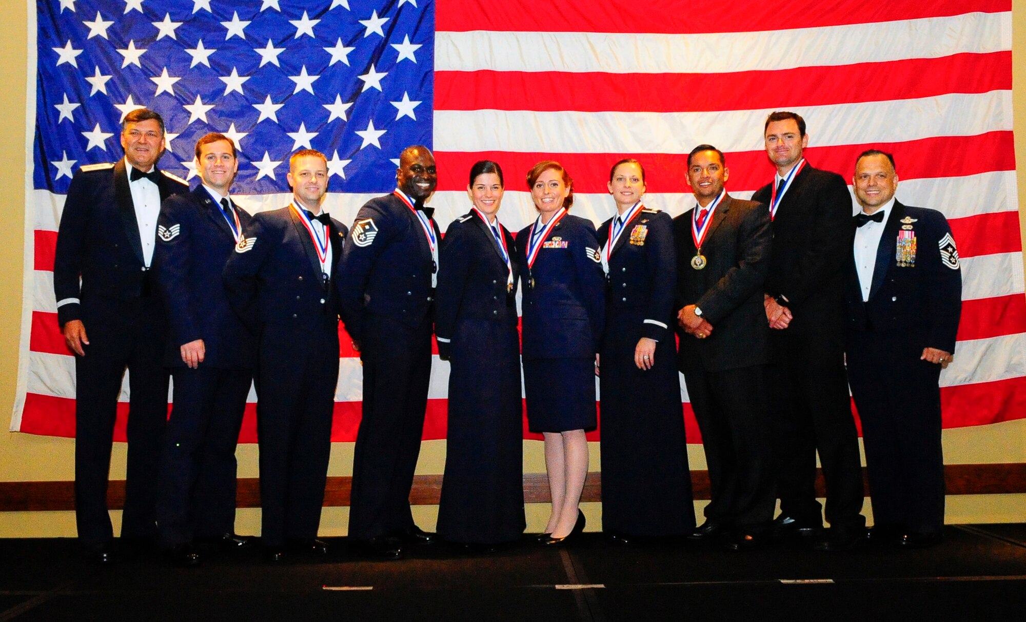 Air Force Special Operations Command's 2014 Outstanding Airmen and civilians of the year were honored at the yearly awards banquet held May 14 to celebrate their accomplishments and 25 years of AFSOC history.  Lt. Gen. Brad Heithold (left), AFSOC commander and CMSgt. Matt Caruso (right), command chief, presented awards to this year's honorees -- Staff Sgt. Travis Jordan, Airman of Year; Tech. Sgt. William Phelps, noncommissioned officer of year; Master Sgt. Daniel Wey, senior noncommissioned officer of year; Master Sgt. Marvin Jimerson, first sergeant of year; Capt. Samantha Ekwall, company grade officer of year; Staff Sgt. Danielle Szymczyk, individual reservist of year (enlisted); Capt. Stefanie Purdie, individual reservist of year (officer); Samuel Krahn, civilian of year category I; Daniel Wilcoxen, civilian of year category II; Jorge Talamantes, civilian of year category III.