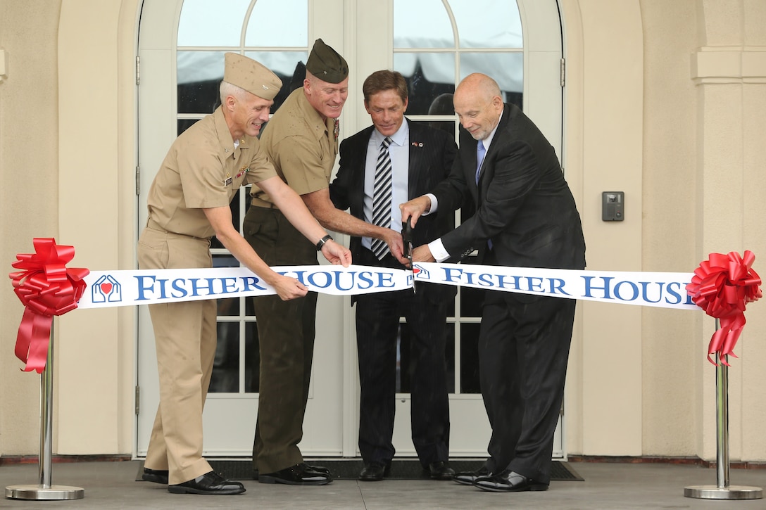 Navy Capt. Mark A. Kobelja, Commanding Officer, Naval Hospital Camp Pendleton; Brig. Gen. Edward D. Banta, Commanding General, Marine Corps Installations West - Marine Corps Base Camp Pendleton; Kenneth Fisher, chairman and chief executive officer of the Fisher House Foundation and John M. Mateczun, president of UnitedHealthcare Military and Veterans, cut the ribbon during the Fisher House opening ceremony, May 15. The new Camp Pendleton Fisher House will provide free temporary housing facilities for military families visiting wounded Marines and Sailors at the base Naval Hospital. 