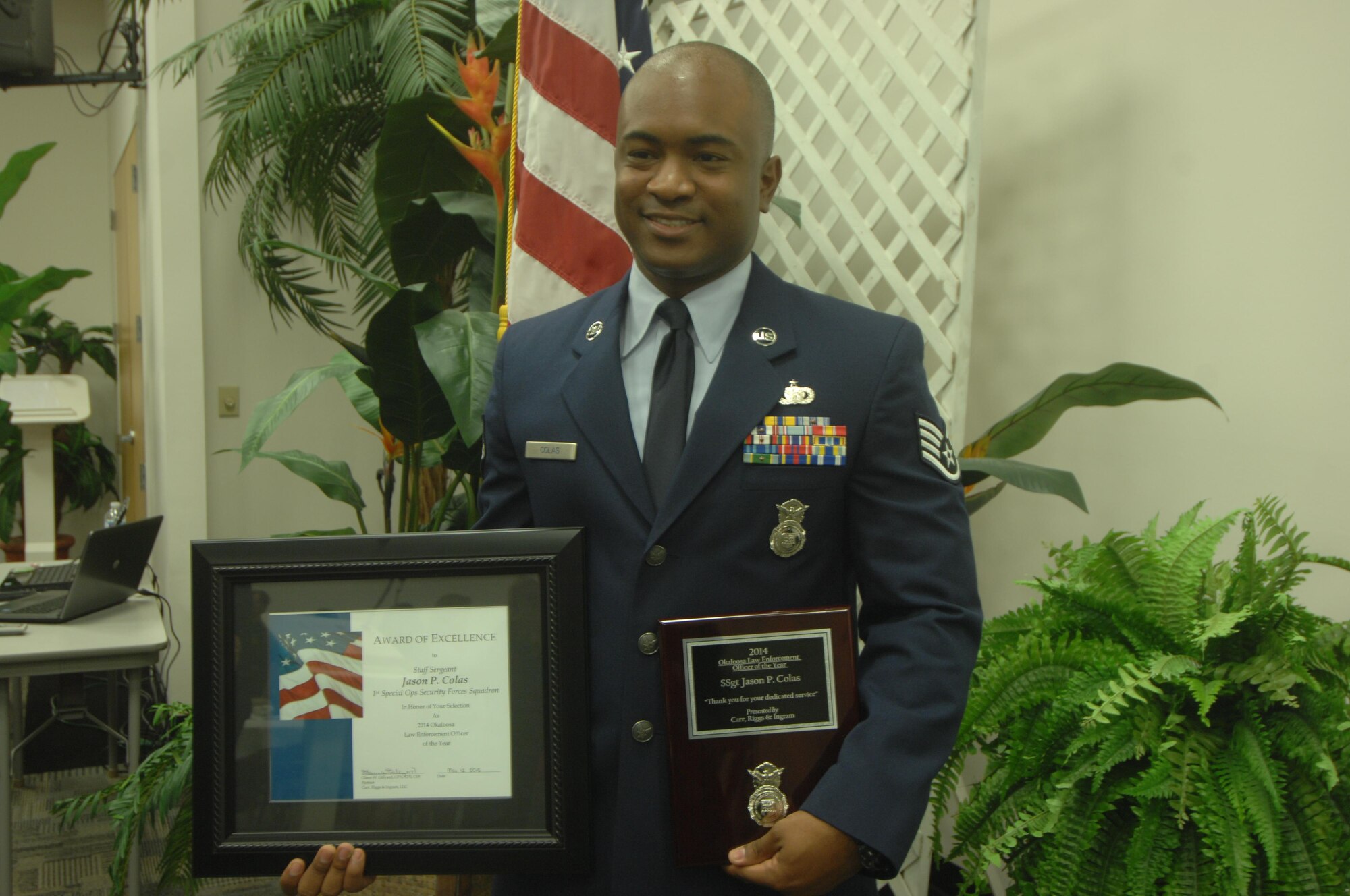 Staff Sgt.Jason Colas, 1st Special Operations Security Forces Squadron security forces ground intelligence NCO in-charge, poses after being named  the 2014 Okaloosa County Law Enforcement Officer of the Year during the Okaloosa County Law Enforcement Appreciation Lunch, May 12, 2015. (Photo courtesy of Northwest Florida Daily News)