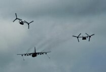 An MC-130P Combat Shadow displays its refueling capabilities beside two CV-22 Ospreys, May 15, 2015, at Hurlburt Field, Fla. Built with 1960s technology, the MC-130P began its special operations career in the mid-1980s and went on to conduct critical air refueling missions in the late 1980s during Operation Just Cause in Panama and the early 1990s during Operation Desert Storm. (U.S. Air Force photo/Airman 1st Class Ryan Conroy) 
