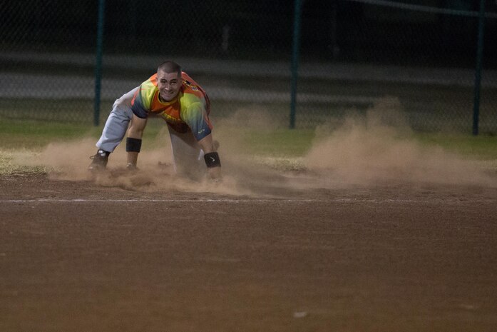 Scott Fisher, the shortstop of 1st Battalion 12th Marine Regiment’s Kings of Battle, regains his feet after he rounds third base after a deep ball into the outfield April 20, 2015, at Riseley Field. Fisher was able to recover from his fall and score a run for the team. (U.S. Marine Corps photo by Cpl. Khalil Ross/Released)