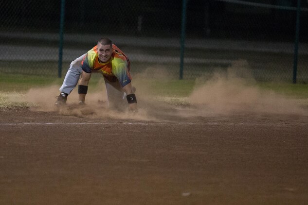 Scott Fisher, the shortstop of 1st Battalion 12th Marine Regiment’s Kings of Battle, regains his feet after he rounds third base after a deep ball into the outfield April 20, 2015, at Riseley Field. Fisher was able to recover from his fall and score a run for the team. (U.S. Marine Corps photo by Cpl. Khalil Ross/Released)