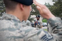 An 8th Security Forces Squadron Airman salutes the U.S. flag honoring security forces members who made the ultimate sacrifice during the conclusion of a retreat ceremony May 15, 2015, at Kunsan Air Base, Republic of Korea. Originally proclaimed Peace Officers Memorial Day in 1962 by President John F. Kennedy, May 15 and the week it falls in has since been designated as a time to pay tribute to local, state and federal law enforcement professionals.  (U.S. Air Force photo by Senior Airman Katrina Heikkinen/Released)