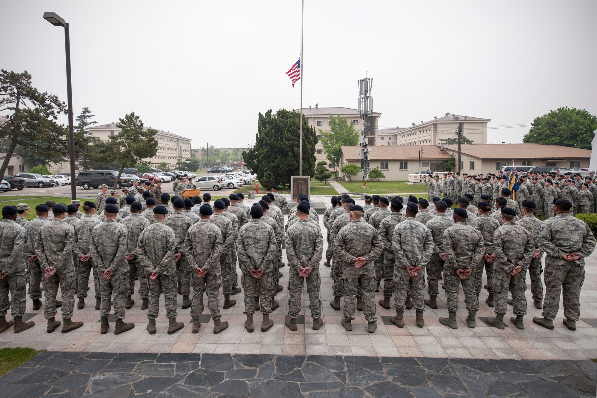 Wolf Pack Airmen stand in formation to honor security forces members who made the ultimate sacrifice in the line of duty during a retreat ceremony May 15, 2015, at Kunsan Air Base, Republic of Korea. Members of the Wolf Pack recognized the importance of crime prevention during National Police Week various observances, including demonstrations by the military work dog section, combat arms and weapons display, crime prevention skits and defender challenge. (U.S. Air Force photo by Senior Airman Katrina Heikkinen/Released)