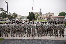 Wolf Pack Airmen stand in formation to honor security forces members who made the ultimate sacrifice in the line of duty during a retreat ceremony May 15, 2015, at Kunsan Air Base, Republic of Korea. Members of the Wolf Pack recognized the importance of crime prevention during National Police Week various observances, including demonstrations by the military work dog section, combat arms and weapons display, crime prevention skits and defender challenge. (U.S. Air Force photo by Senior Airman Katrina Heikkinen/Released)