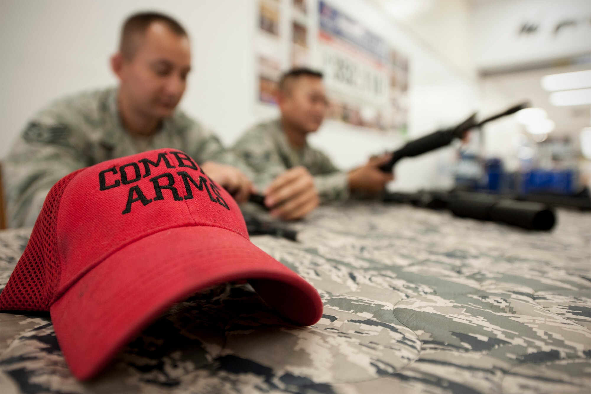 Staff Sgt. Ruben Salazar and Senior Airman Michael Vue, 8th Security Forces Squadron combat arms instructors, explain the function of various weapons during the Wolf Pack’s National Police Week observance May 12, 2015. Originally proclaimed Peace Officers Memorial Day in 1962 by President John F. Kennedy, May 15 and the week it falls in has since been designated as a time to pay tribute to local, state and federal law enforcement professionals. (U.S. Air Force photo by Senior Airman Katrina Heikkinen)