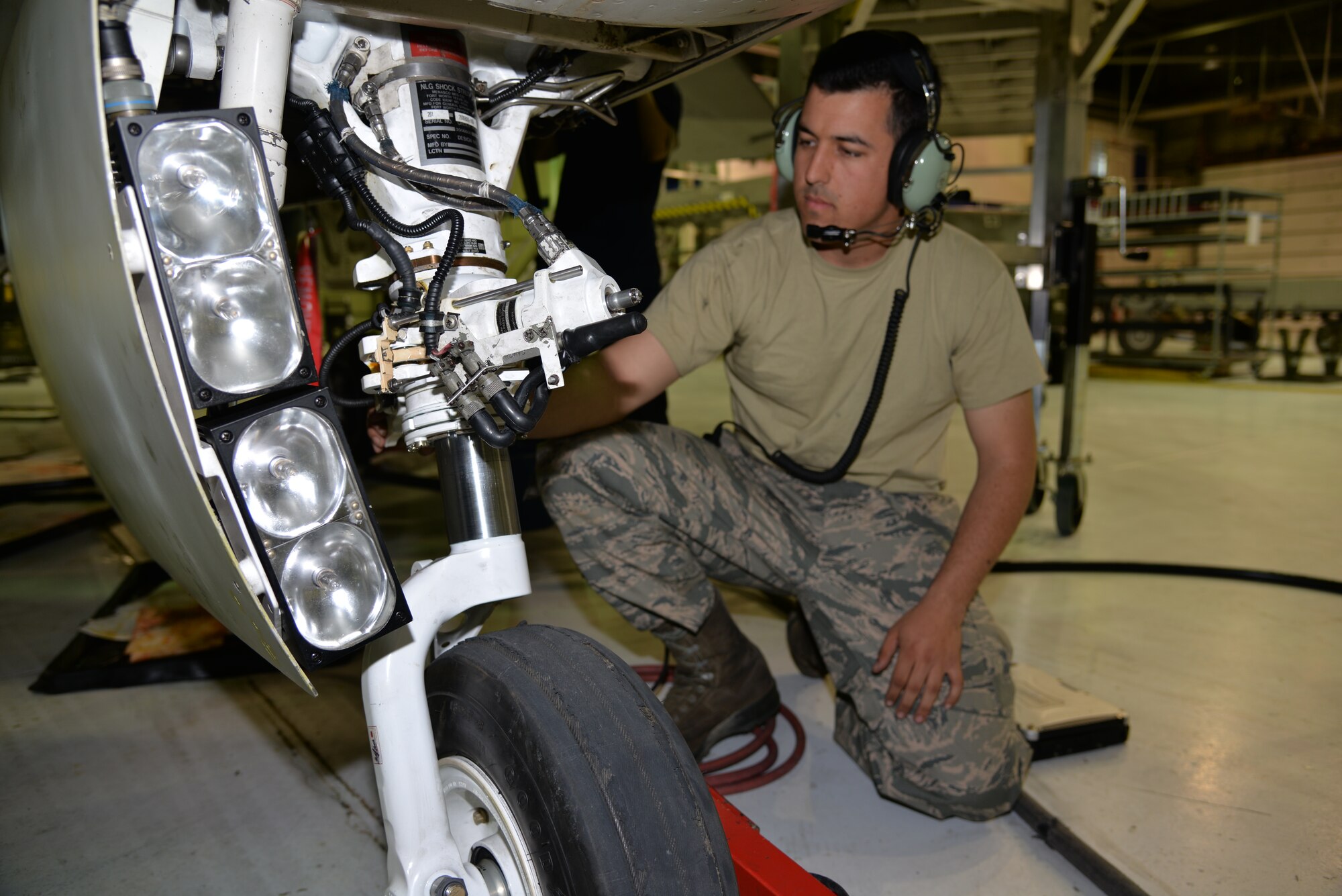 Staff Sgt. Mackenzie Cunningham, a 354th Maintenance Squadron inspection section technician, prepares to do a check of hydraulic functions in the forward landing gear of an F-16 Fighting Falcon assigned to the 18th Aggressor Squadron. All Aggressor aircraft are scheduled for approximately 10 days of downtime every 300 flying hours in which the jet must undergo a thorough maintenance inspection at the phase shop. (U.S. Air Force photo by Staff Sgt. Kirsten Wicker/Released)