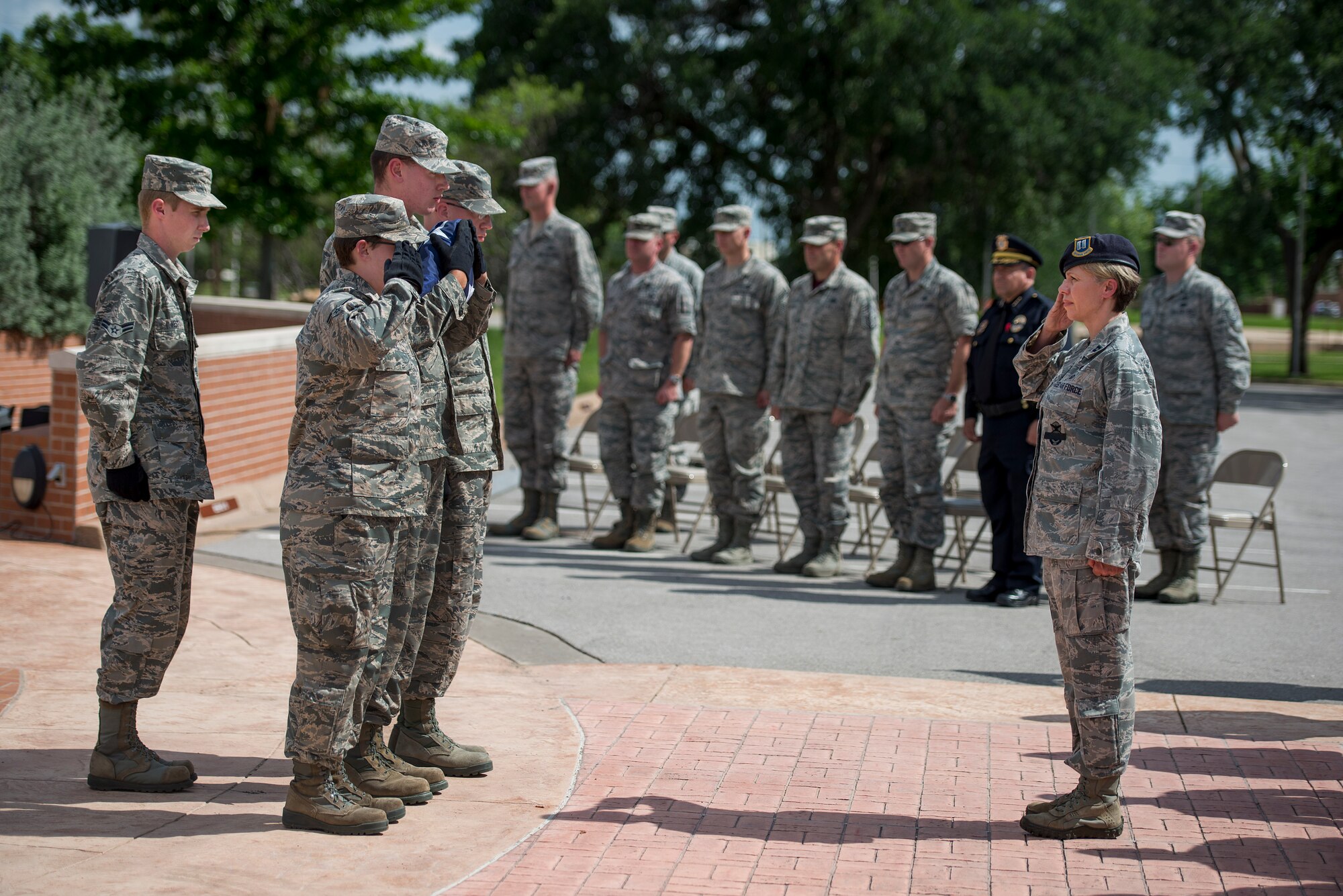 U.S. Air Force flag security detail Airmen present the U.S. flag to U.S. Air Force Capt. Yonca Nice, 82nd Security Forces Squadron flight commander, in the National Police Week retreat ceremony with the Wichita Falls Police Department at Sheppard Air Force Base, Texas, May 15, 2015. A report from the National Law Enforcement Officers Memorial Fund states that 126 police officers were killed in the line of duty in 2014. The retreat ceremony was dedicated to honoring those fallen officers. (U.S. Air Force photo by Senior Airman Kyle Gese/Released)