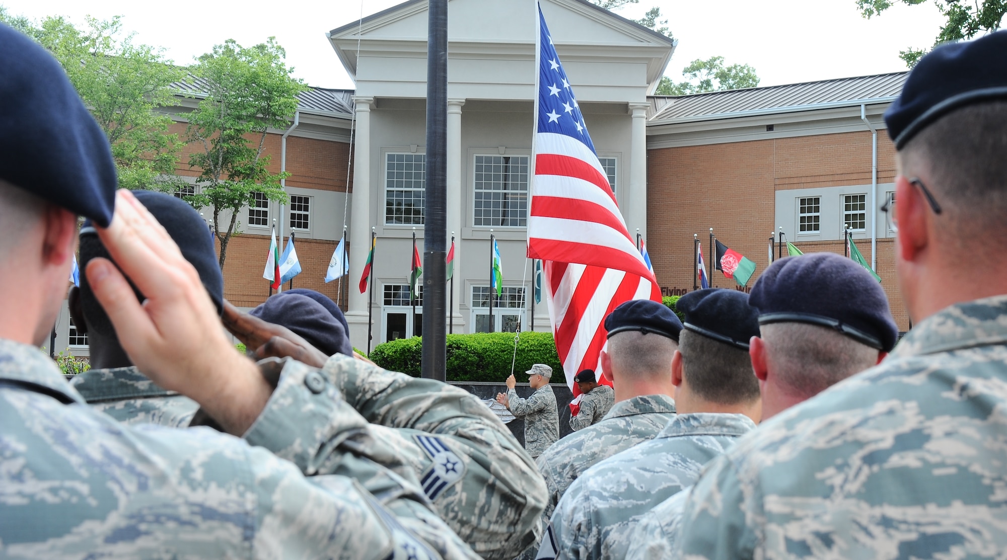 14th Security Forces Squadron Airmen salute the flag during the Columbus Air Force Base Police Week retreat ceremony May 15 at Smith Plaza. After a week of celebration, defenders closed the events by honoring all the fallen officers who sacrificed their lives in the past year. (U.S. Air Force photo/Senior Airman Kaleb Snay)