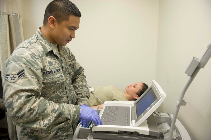 Airman 1st Class Alvin Maximo-Acorda, 99th Medical Surgical Operations Squadron cardiopulmonary technician, simulates an electrocardiogram test on Airman 1st Class Tiffany Robertson, 99th  MSGS, at the Cardiopulmonary Clinic on Nellis Air Force Base, Nev., May 12, 2015. An electrocardiogram checks for problems with the electrical activity of a patient’s heart. (U.S. Air Force photo by Airman 1st Class Rachel Loftis)