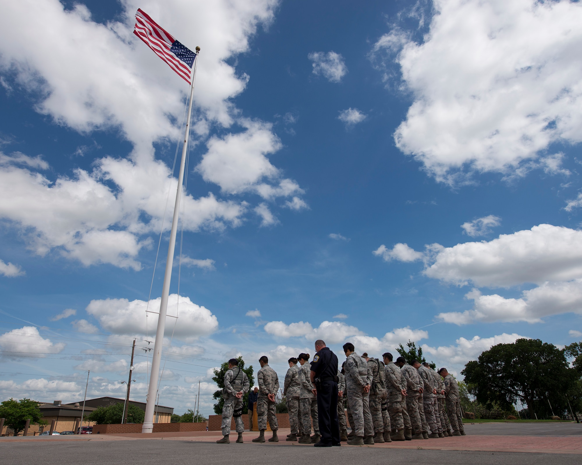 Airmen from the 82nd Training Wing attend a retreat ceremony with officers from the Wichita Falls Police Department at Sheppard AFB, Texas, May 15, 2015. May 15 is dedicated as National Peace Officers Day and is recognized in both the military and civilian communities. The week this remembrance day falls in is also known as National Police Week. (U.S. Air Force photo by Senior Airman Kyle Gese/Released)