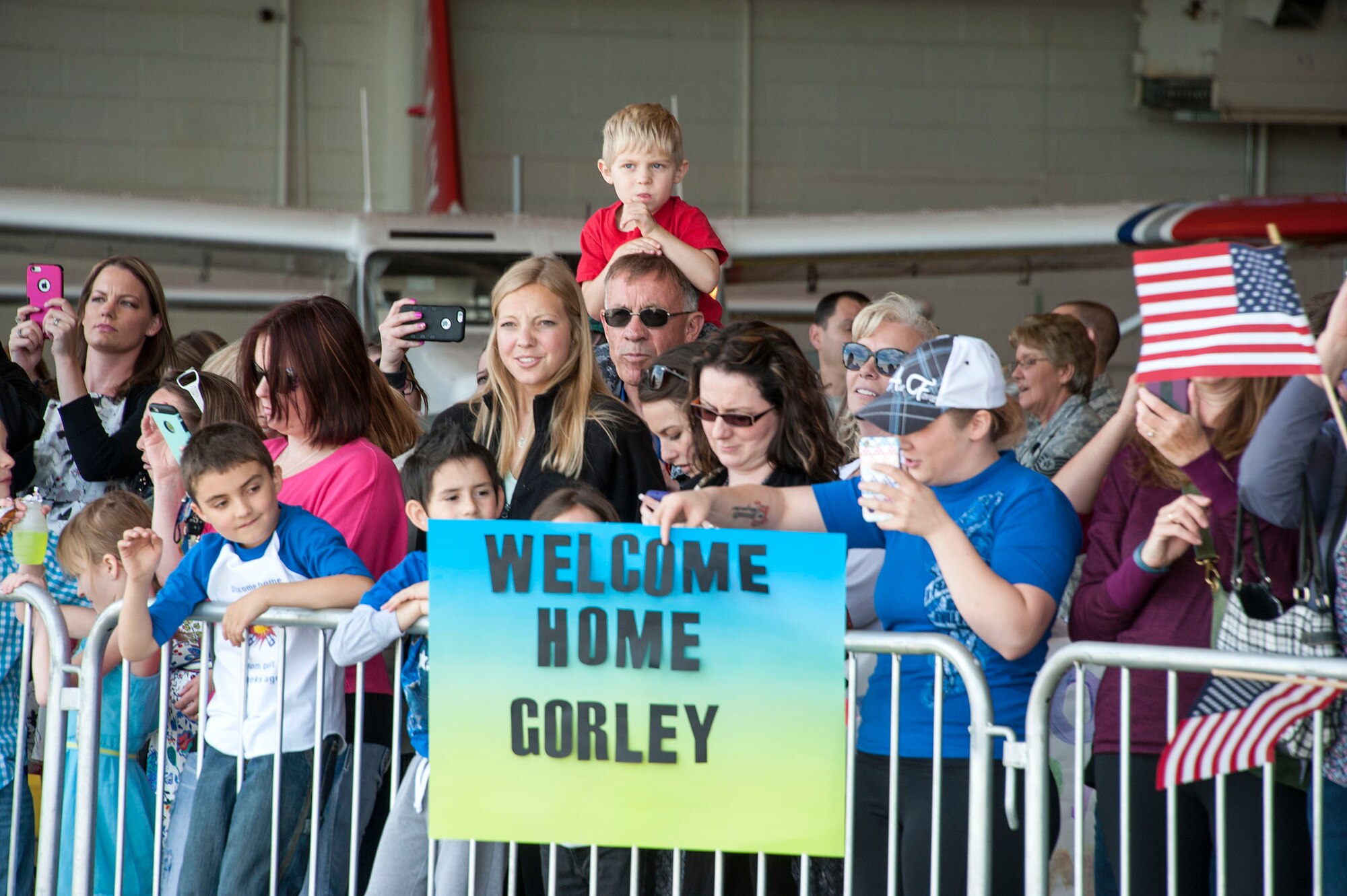 Family and friends of 140th Wing members anxiously await the arrival of their loved ones at Buckley AFB, Colo. May 15, 2015. Over 200 Airmen from the Colorado Air National Guard unit returned home after being deployed as a Theater Security Package to the Republic of Korea for the past three months. (U.S. Air National Guard photo by Senior Master Sgt. John Rohrer) 