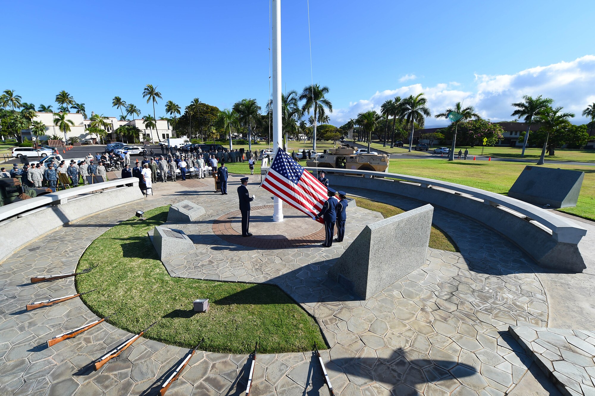 15th Wing and Joint Base leadership, enforcement officers  from JBPHH and local community as well as Airmen, Sailors, Coastguardsmen and civilians, look on as members of the honor guard raise the flag to half-staff in honor of National Peace Officers’ Memorial Day at JBPHH, Hawaii, May 15, 2015. In addition to the closing ceremony, the 647th Security Forces Squadron Defenders hosted several community events throughout the week, which began May 11 with a 5K ruck march. A parade through Hickam Communities and a police fair at the Navy Exchange also gave the Defenders an opportunity to interact with the local community while demonstrating some of their unique capabilities. (U.S. Air Force photo by Tech. Sgt. Aaron Oelrich/RELEASED)