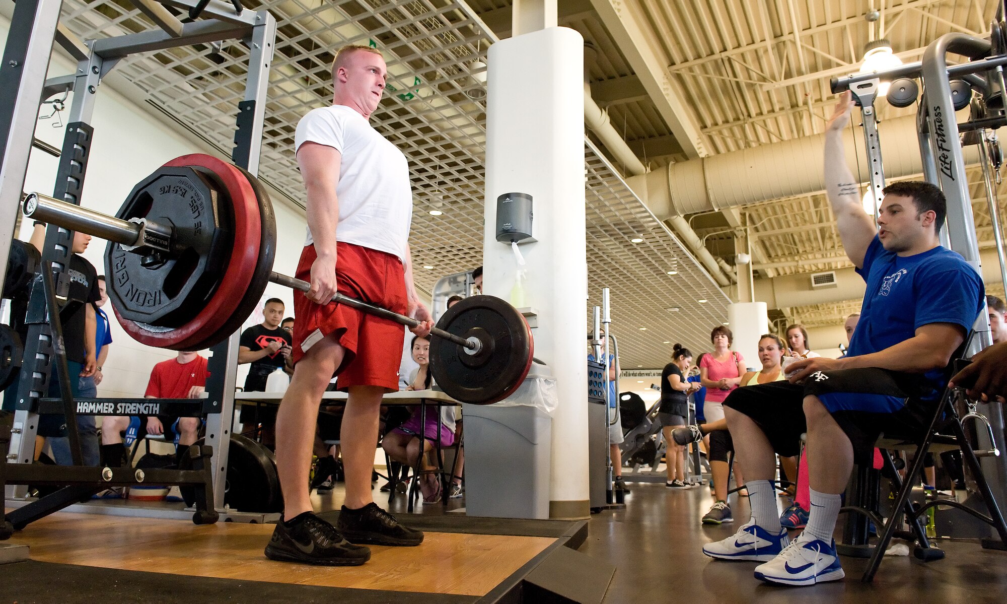 Lance Wright, left, waits for judge Scott Day, right, to signal a good lift of 405 pounds on his first of three deadlift attempts during the powerlifting competition May 8, 2015, at the Fitness Center on Dover Air Force Base, Del. Wright placed fifth in the male 181-pound weight class with a combined total of 1,000 pounds for the squat, bench press and deadlift. (U.S. Air Force photo/Roland Balik)