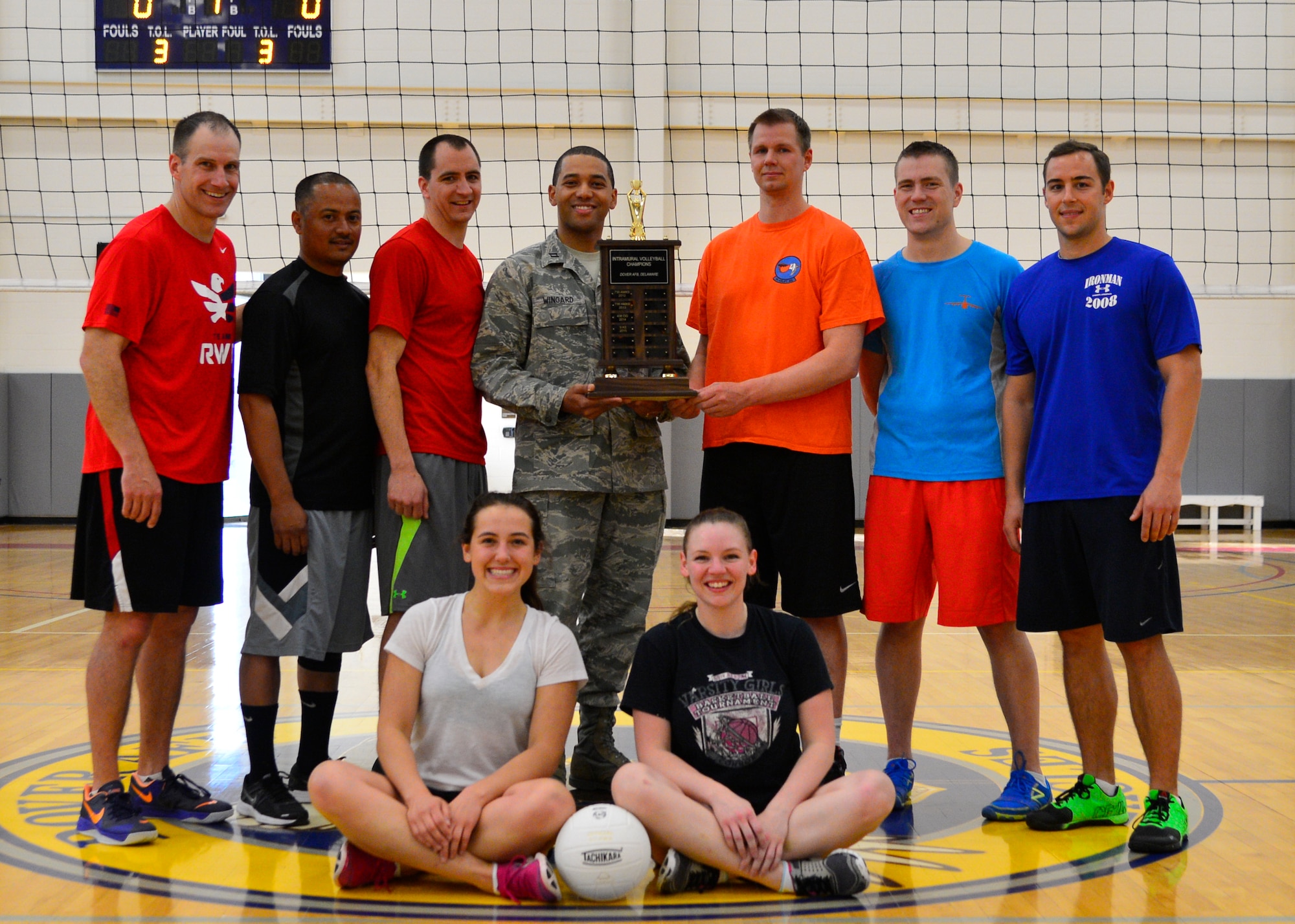 Capt. Walter Wingard, Jr., 436th Force Support Squadron Sustainment Flight commander, presents the 9th Airlift Squadron volleyball team with the 1st place championship trophy May 14, 2015, at the Fitness Center on Dover Air Force Base, Del. The 9th AS defeated the combined 436th and 736th Aircraft Maintenance Squadrons, 16-25, 25-18 and 15-7, to win the championship. (U.S. Air Force photo/Airman 1st Class William Johnson)