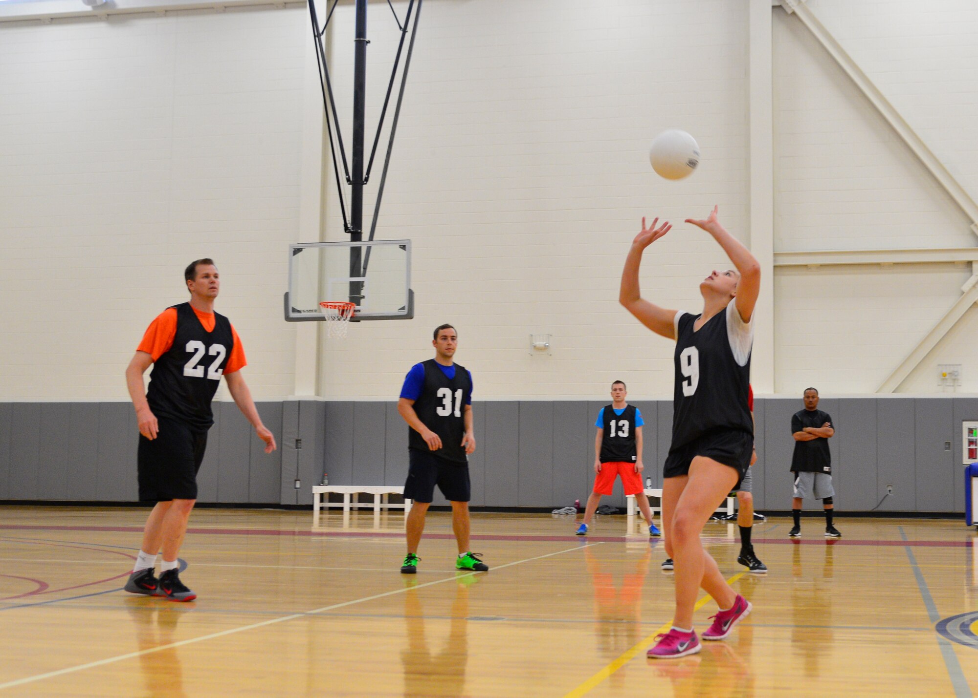 Leah Peterson, 9th Airlift Squadron, sets a volleyball to Ryan Mozingo, 9th AS, 22, during the intramural volleyball championship against the combined 436th and 736th Aircraft Maintenance Squadrons May 14, 2015, at the Fitness Center on Dover Air Force Base, Del. The 9th AS defeated AMXS in the three-game series, 16-25, 25-18, and 15-7 to win the championship. (U.S. Air Force photo/Airman 1st Class William Johnson)