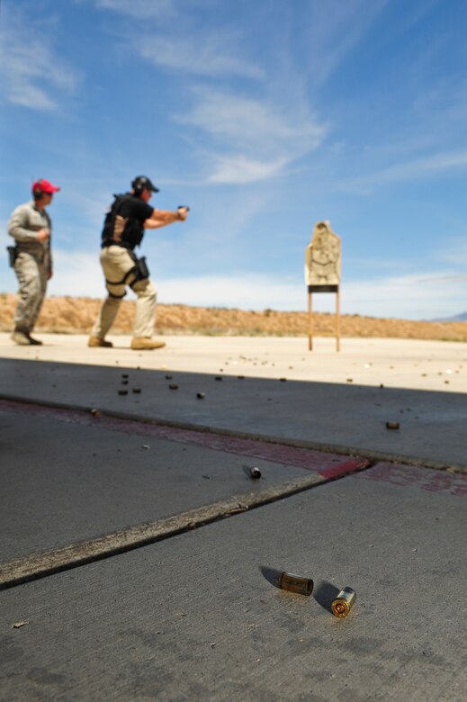 Shell casings litter the surface of the Combat Arms Training and Maintenance course during the practice round of a firing competition at Davis-Monthan Air Force Base, Ariz., May 13, 2015. The competition was held in conjunction with National Police week and consisted of several law enforcement agencies at D-M including the 355th Security Forces Squadron, Air Force Office of Special Investigations and Homeland Security Investigations. (U.S. Air Force photo by Airman 1st Class Chris Drzazgowski/Released)