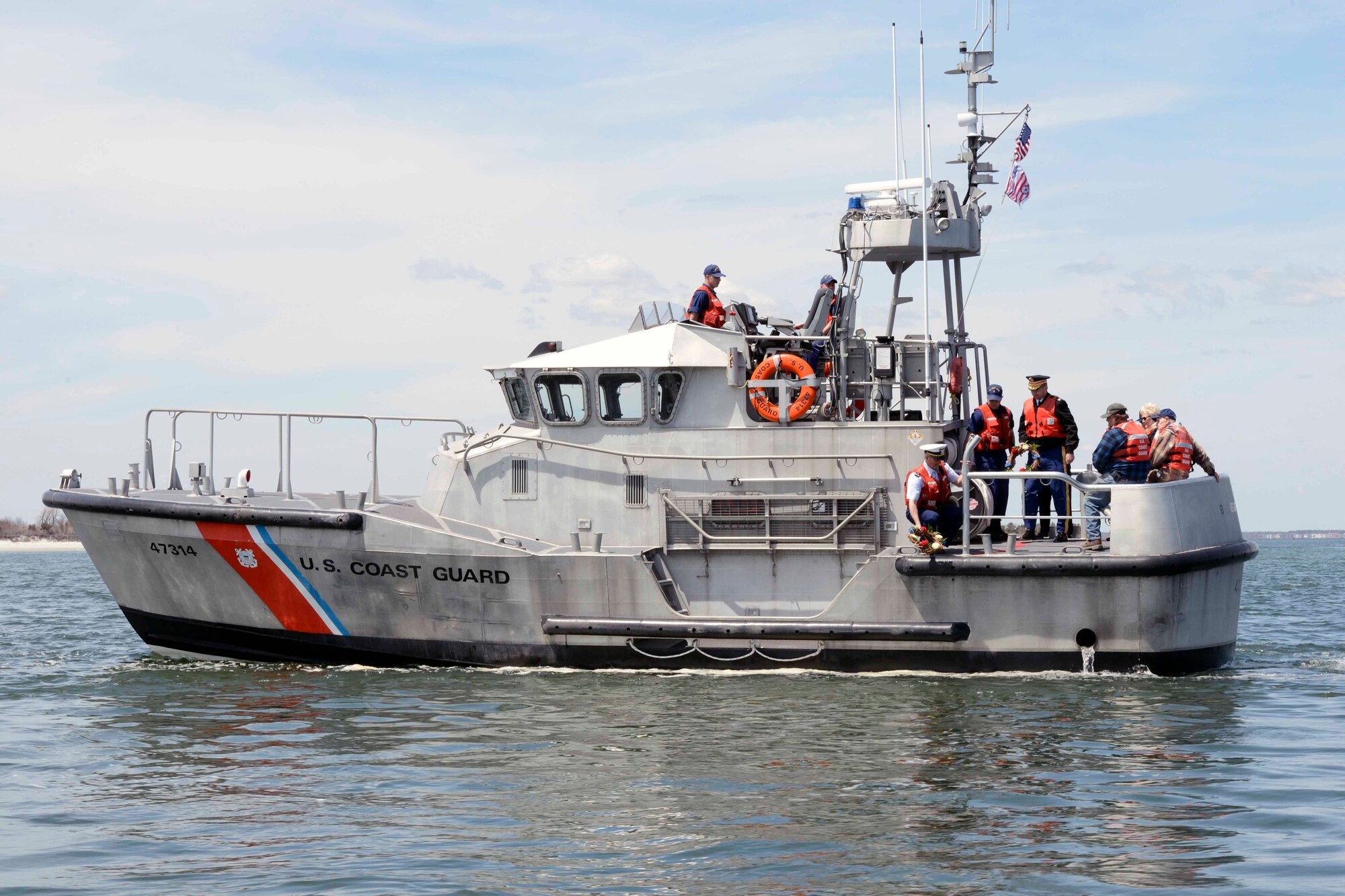 Chief Warrant Officer Kevin Speer, commanding officer of Coast Guard Station Barnegat Light, N.J., prepares to place a wreath in Barnegat Inlet Monday, April 28, 2014. The wreath was laid to honor the Soldiers and Sailors who lost their lives during the World War II Battle of Exercise Tiger, April 28, 1944. (U.S. Coast Guard photo by Petty Officer 3rd Class Cynthia Oldham/Released)