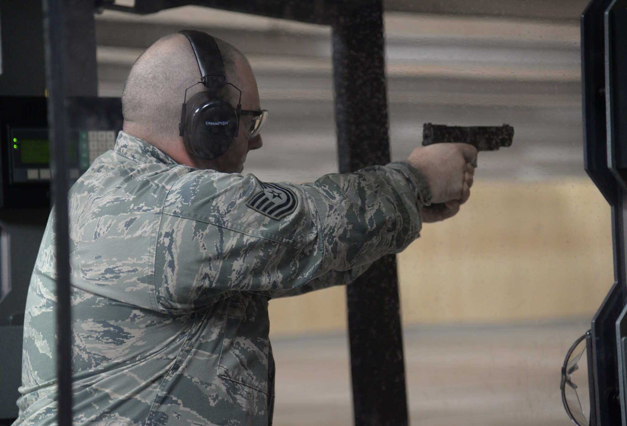 Tech. Sgt. David Weatherley, 85th Engineering Installation Squadron team member, shoots his pistol during the team shoot competition to celebrate National Police Week, May 14, 2015, Keesler Air Force Base, Miss. The 81st Security Forces Squadron held different events throughout the week to honor fallen security forces and Mississippi state law enforcement while educating the public on law enforcement duties and programs. (U.S. Air Force photo by Senior Airman Holly Mansfield)
