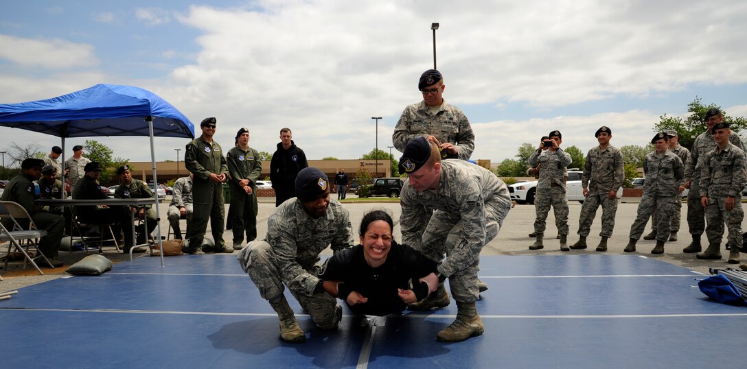 Airman 1st Class Amanda Mascorro, 11th Security Forces Squadron elite gate guard, is tased as part of a National Police Week demonstration May 13, 2015, at Joint Base Andrews, Md. The demonstration offered security forces personnel the opportunity to display their dedication, and JBA members to experience what their responsibilities might be like. (U.S. Air Force photo by Senior Airman Preston Webb)