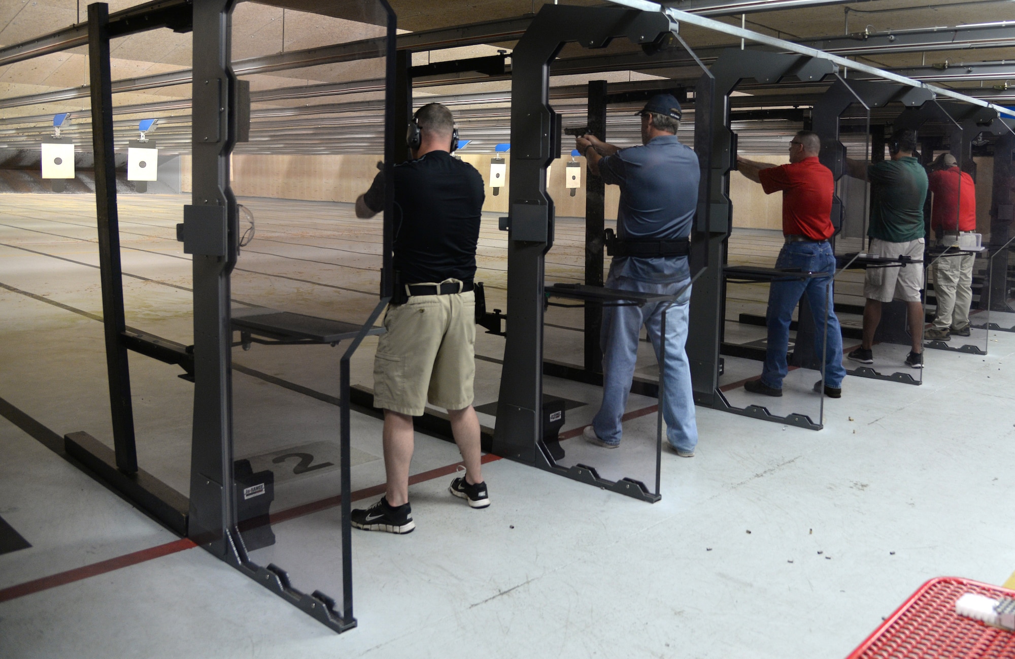 Members of the 81st Logistics Readiness Squadron team shoot at targets during the team shoot competition to celebrate National Police Week, May 14, 2015, Keesler Air Force Base, Miss. The 81st Security Forces Squadron held different events throughout the week to honor fallen security forces and Mississippi state law enforcement while educating the public on law enforcement duties and programs. (U.S. Air Force photo by Senior Airman Holly Mansfield)