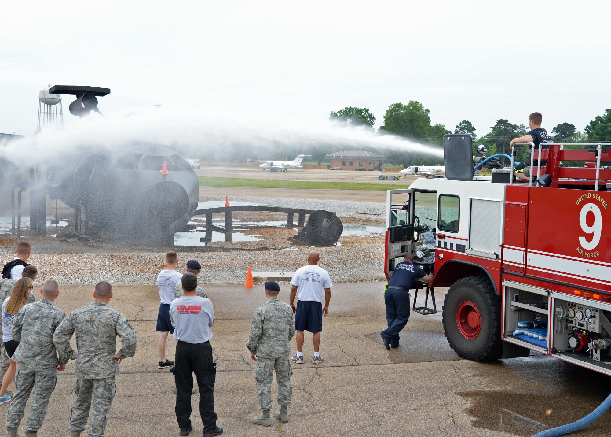 Airmen from the 14th Security Forces Squadron fire a water turret at cones on the “Burn Plane” on Columbus Air Force Base, Mississippi, May 14 during the Battle of the Badges competition held during National Police Week. During Battle of the Badges, 14th SFS Airmen faced off against Airmen from the 14th Civil Engineer Squadron Fire Department in activities such as land navigation, weapons firing, capture the flag, firewater accuracy, and softball. (U.S. Air Force Photo/Senior Airman Stephanie Englar)
