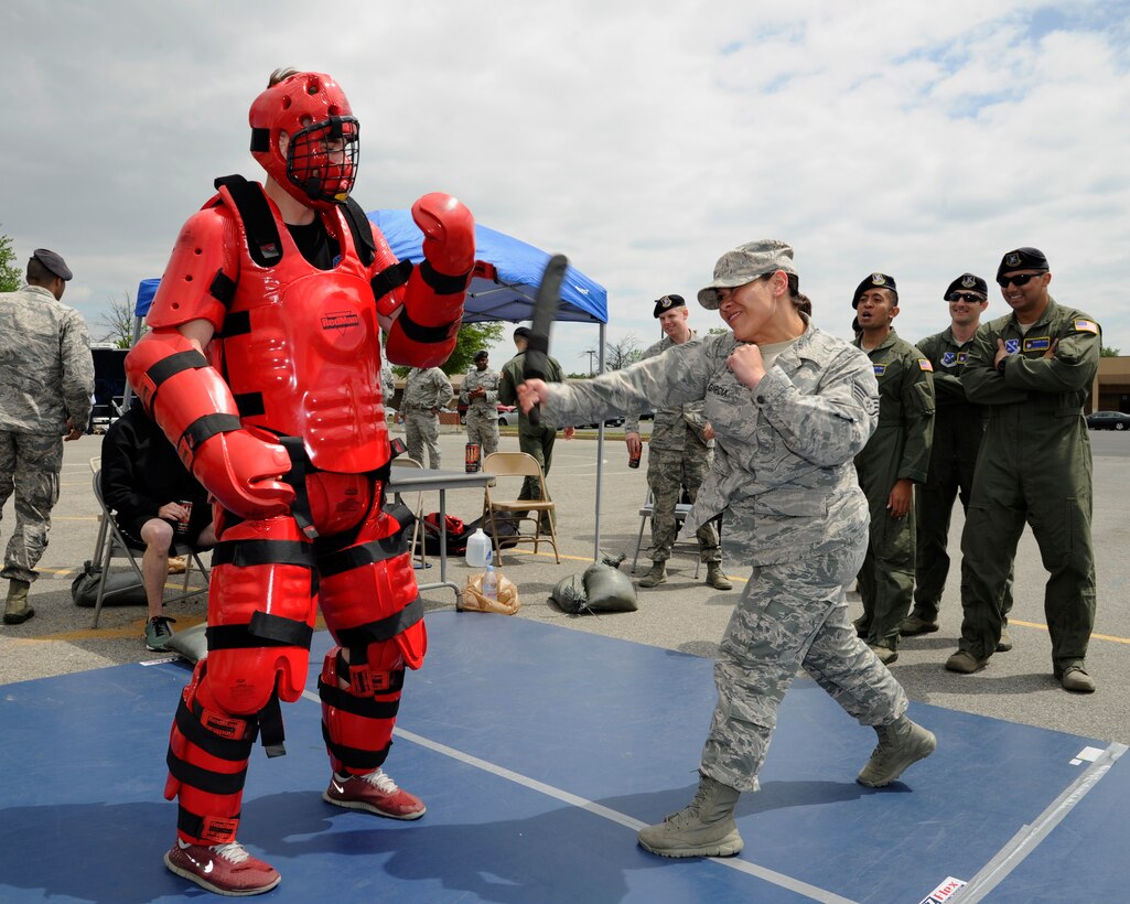 Staff Sgt. Raquel Garcia, 11th Security Forces Support Squadron non-commissioned officer in charge of supply, swings a baton at Airman 1st Class Luke Gibson, 811th Security Forces Squadron raven, during a National Police Week demonstration May 13, 2015, at Joint Base Andrews, Md. The demonstration offered Security Forces an opportunity to show JBA members what their responsibilities might include on a given day. (U.S. Air Force photo by Senior Airman Preston Webb)