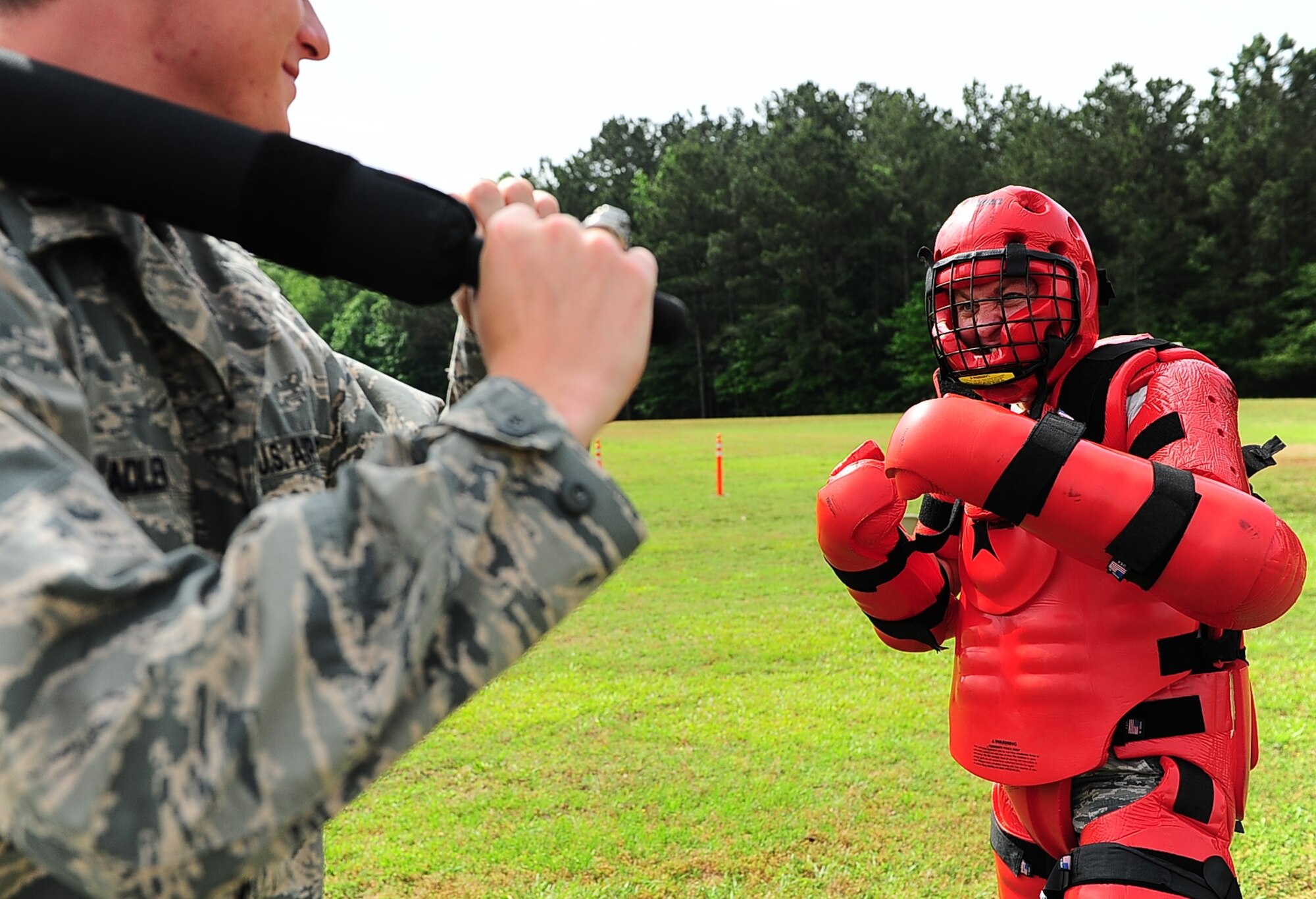 Chief Master Sgt. Mark Cantrell, 14th Security Forces Command Chief, dons the ‘red man’ suit in preparation for simulated hand-to-hand combat against an attendee of the National Police Week demonstration. The ‘Red Man’ is a foam suit defenders use for baton training when dealing with hostile perpetrators. (U.S. Air Force photo/Airman Daniel Lile)