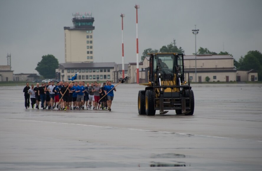 A 10k All-Terrain forklift leads a group of air transportation specialists during the 2015 Port Dawg Memorial Run May 15, 2015, at Ramstein Air Base, Germany. The running group consisted of aerial porters from the 721st Air Mobility Operations Wing, 721st Aerial Port Squadron, 32nd Aerial Port Squadron, 603rd Air Operations Center, 435th Air Mobility Squadron, 86th Logistics Readiness Squadron and Headquarters U.S. Air Forces in Europe.  (U.S. Air Force photo by Staff Sgt. Jonathan Hehnly)