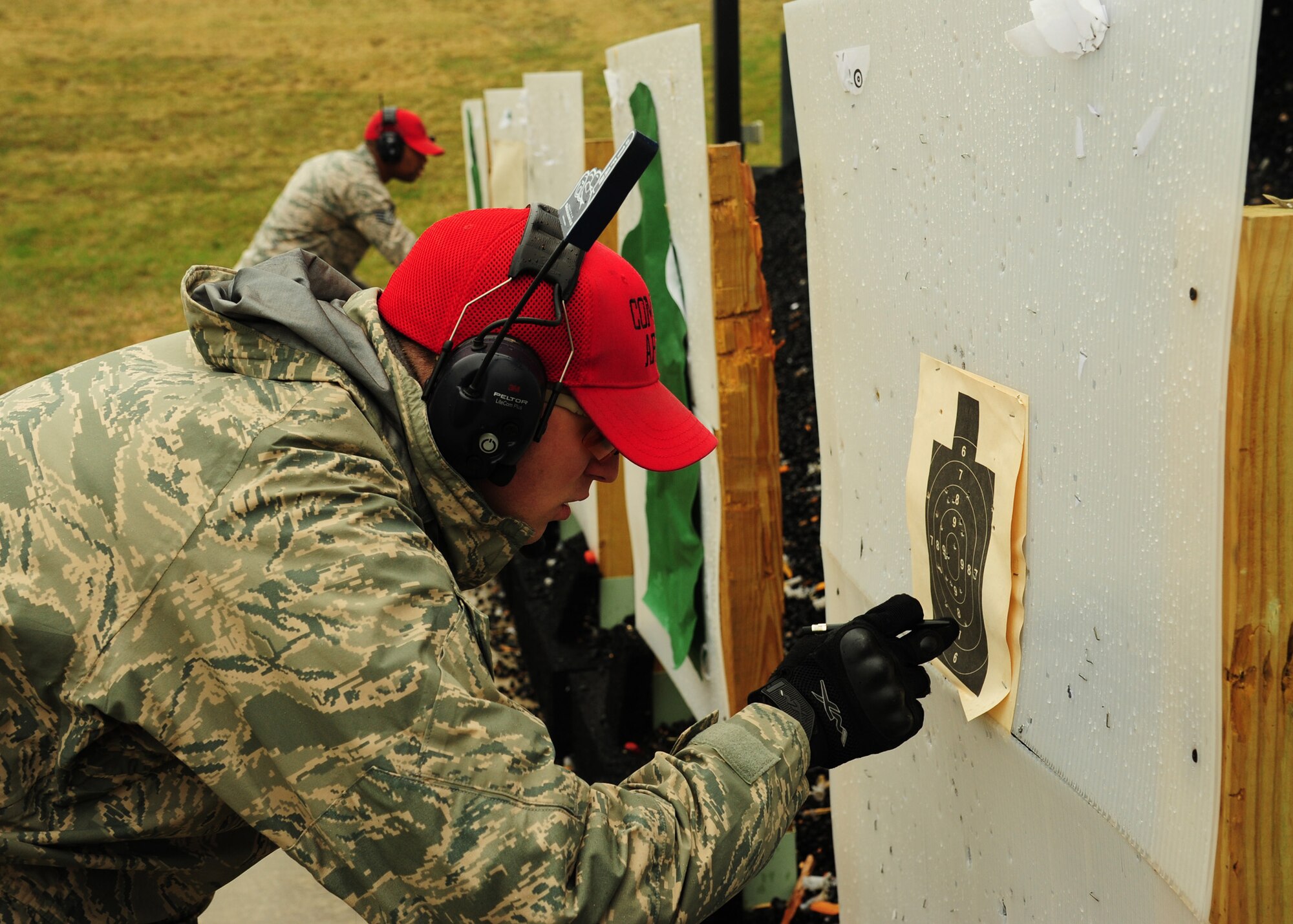 Staff Sgt. Frank Witmer, 319th Security Forces Squadron combat arms instructor, calculates a competitor’s score in the 2nd Annual Police Week Shooting Competition May 13, 2015, at the Grand Forks Public Service Training Center in Grand Forks, N.D. The competitors represented several law enforcement agencies from as far away as the Canadian border. (U.S. Air Force photo by Airman 1st Class Ryan Sparks/released)