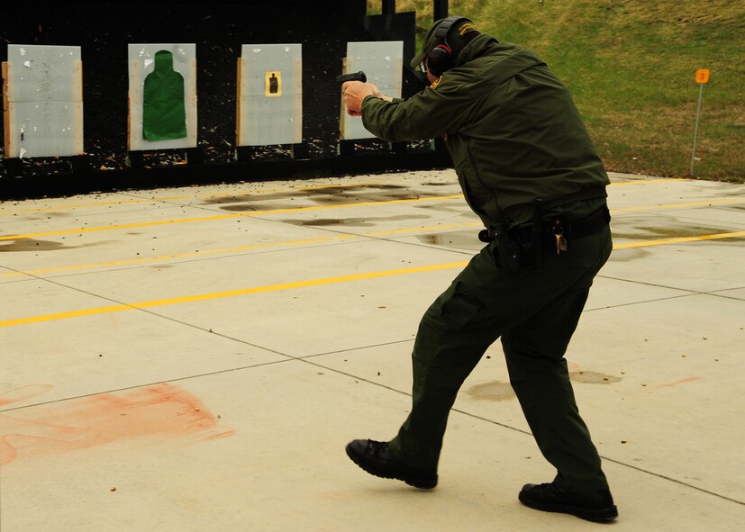 Roy Dahlstrom, U.S. Border Patrol acting division chief, charges the target with a pistol May 13, 2015, during the 2nd Annual Police Week Shooting Competition at the Grand Forks Public Service Training Center in Grand Forks, N.D. The USBP was one of several agencies to make the trip to Grand Forks in support of the competition. (U.S. Air Force photo by Airman 1st Class Ryan Sparks/released)