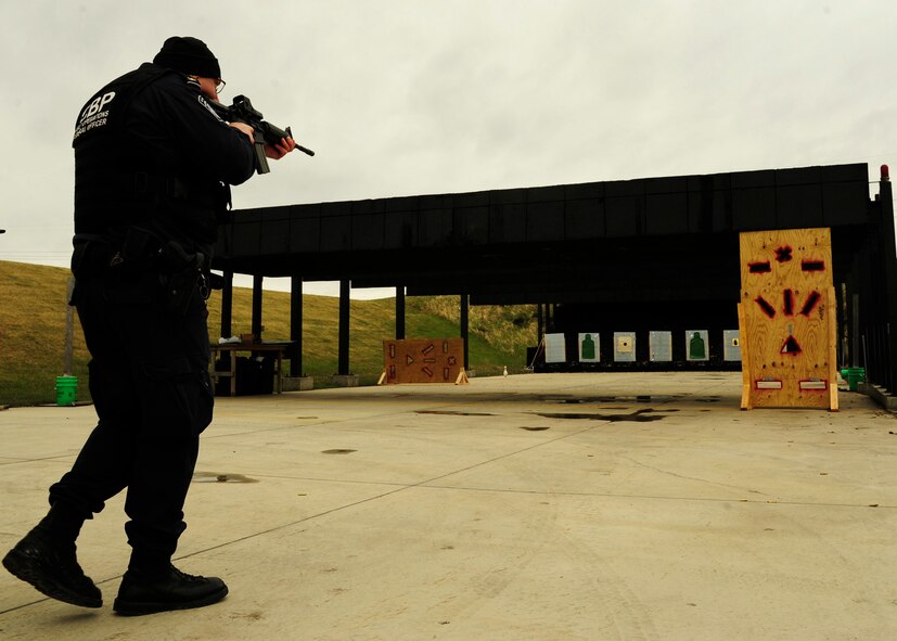 Tom Lipinski, Customs and Border Protection officer, approaches the shooting barrier May 13, 2015, during the 2nd Annual Police Week Shooting Competition at the Grand Forks Public Service Training Center in Grand Forks, N.D. The CBP was one of several agencies that traveled to Grand Forks in support of Police Week. (U.S. Air Force photo by Airman 1st Class Ryan Sparks/released)