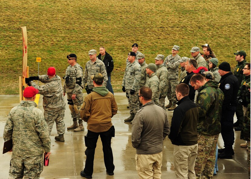 Tech. Sgt. Caleb Cearley, 319th Security Forces Squadron NCO-in-charge of combat arms, demonstrates different firing positions May 13, 2015, at the Grand Forks Public Service Training Center in Grand Forks, N.D. Members of several different agencies came together to compete in the 2nd Annual Police Week Shooting Competition. The competition was organized by the Combat Arms instructors from Grand Forks Air Force Base. (U.S. Air Force photo by Airman 1st Class Ryan Sparks/released)