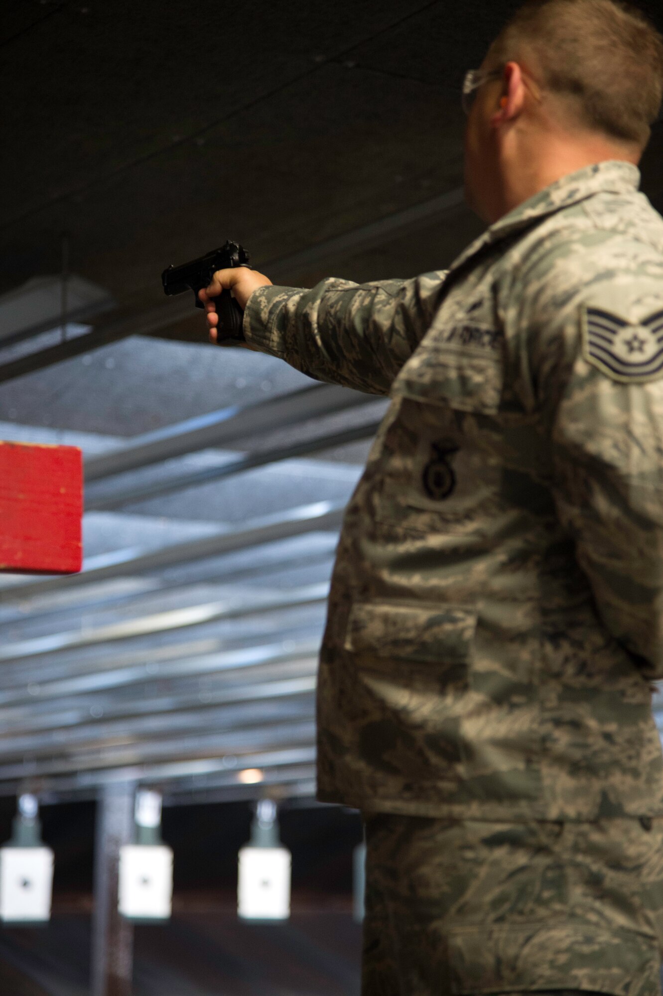 Tech. Sgt. Justin Tentler, 11th Security Support Squadron, shoots during the Excellence in Competition event at the firing range on Joint Base Andrews, Md., May 14, 2015. This National Police Week event brought together approximately 130 people and marked the first time this competition was held on JBA. (U.S. Air Force photo/Airman 1st Class Philip Bryant)