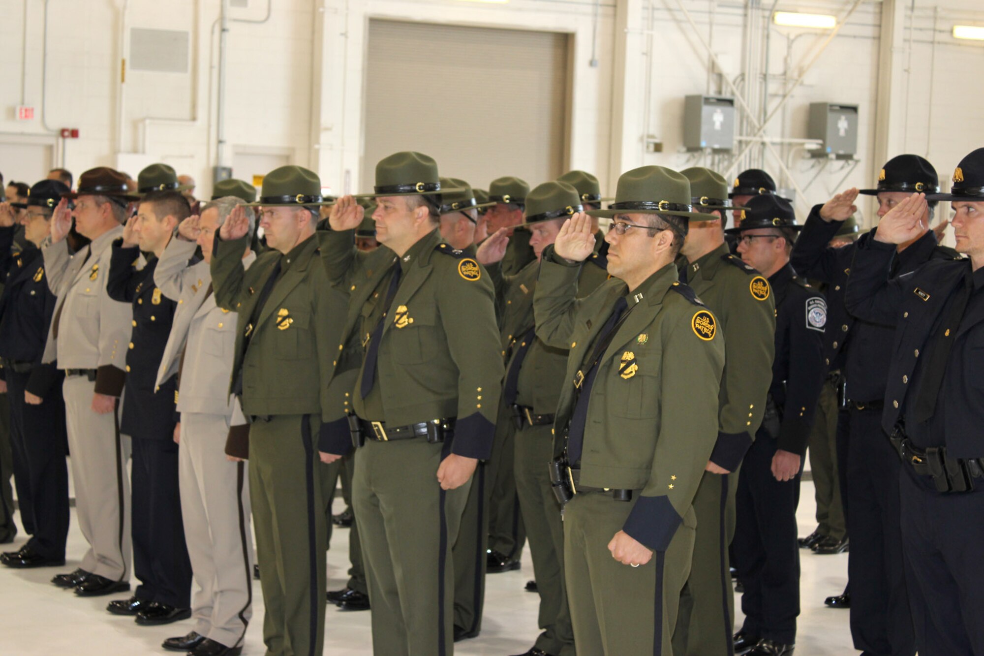 Federal and local law enforcement officers paused during a ceremony on May 15, 2015, at Selfridge Air National Guard Base, Mich., to mark Police Officers Memorial Day.  The event honored the sacrifices of their colleagues who have made the ultimate sacrifice in the line of duty. More than 130 law enforcement officers died while on duty in the U.S. in 2014.  (U.S. Air National Guard photo by Tech. Sgt. Dan Heaton)