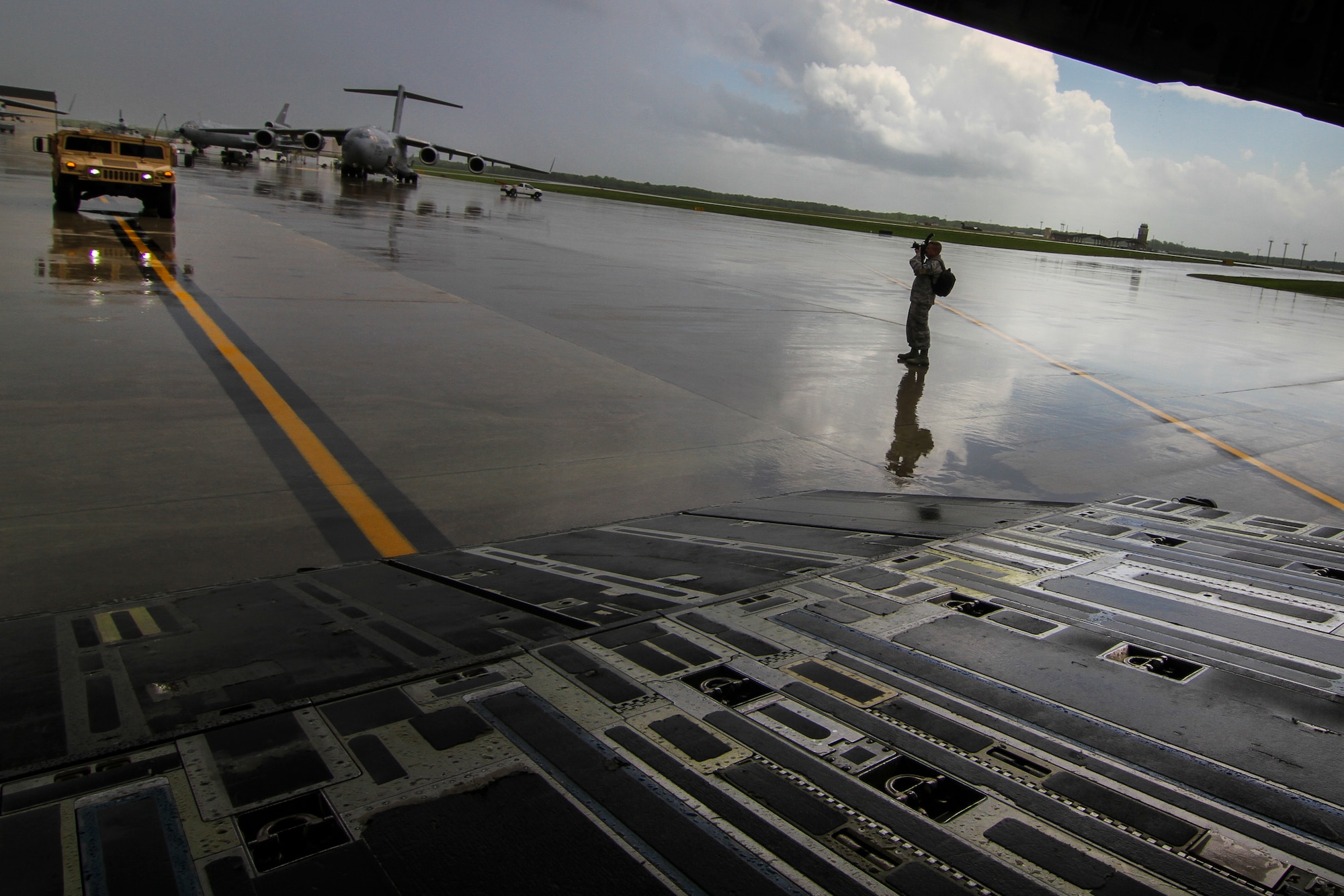Master Sgt. Mark Olsen, 108th Wing Public Affairs photojournalist, documents Humvees that are being prepared for loading onto a C-17 Globemaster III from the New York Air National Guard's 105th Airlift Wing on Joint Base McGuire-Dix-Lakehurst, N.J., May 11, 2015. The 50th ICBT was conducting a deployment exercise testing their cargo movement capabilities. (U.S. Air National Guard photo by Tech. Sgt. Matt Hecht/Released)