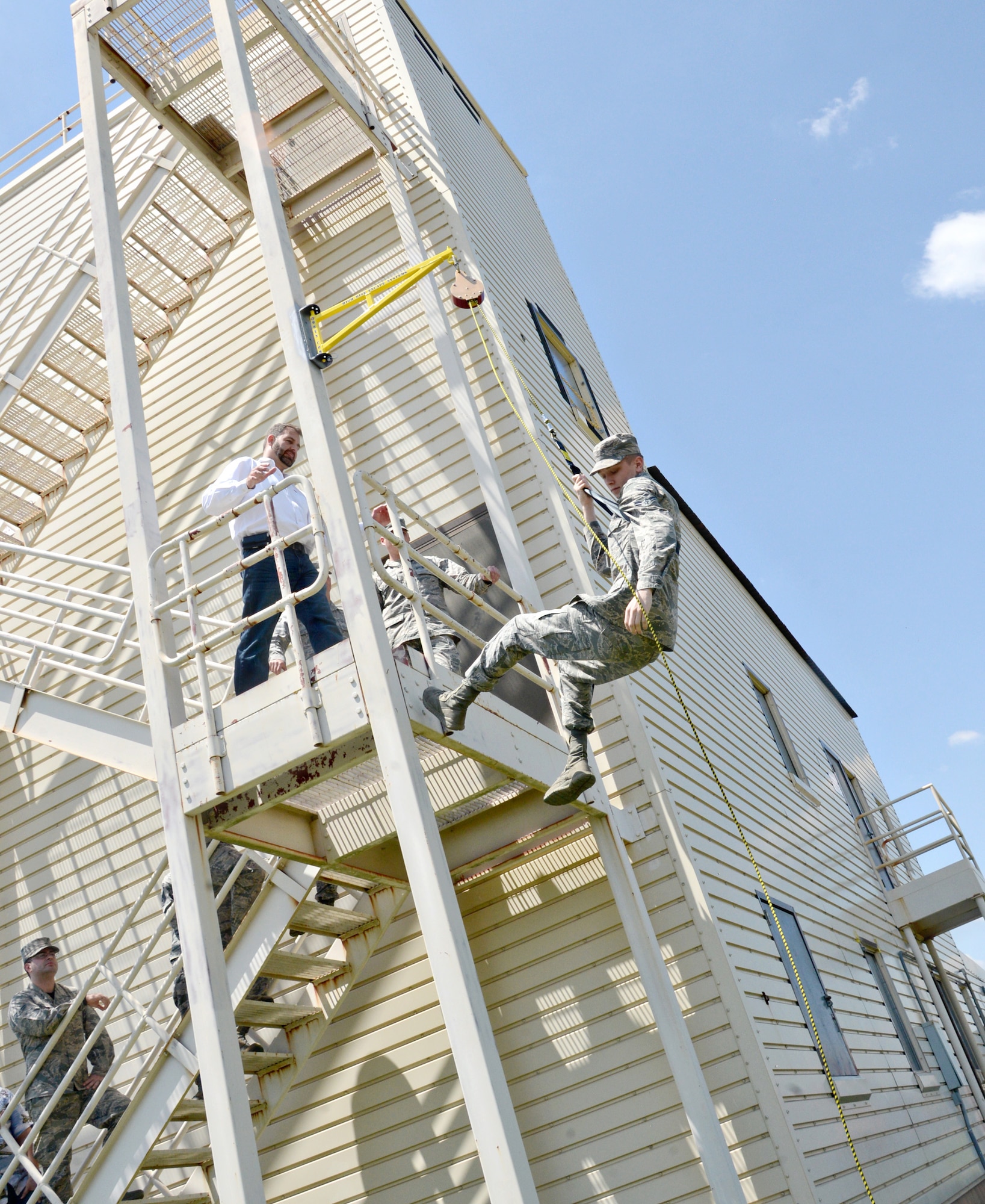 Tinker Fire Department personnel and members of the 72nd Operational Support Squadron attended a training session for the new High Rise Escape System, which will now be used in place of the Baker Life System at the Air Control Tower. Those in attendance of the training were invited to try out the new emergency evacuation system at the fire department’s training facility on the south side of the base. (Air Force photo by Kelly White/Released)