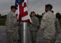 ALTUS AIR FORCE BASE, Okla. – Six members of the 97th Security Forces Squadron prepare and raise the flag for reveille in honor of Police Week at Wings of Freedom Park, May 15, 2015. The ceremony was followed by the placement of a wreath to honor fallen Defenders. (U.S. Air Force photo by Senior Airman J. Zuriel Lee/Released)