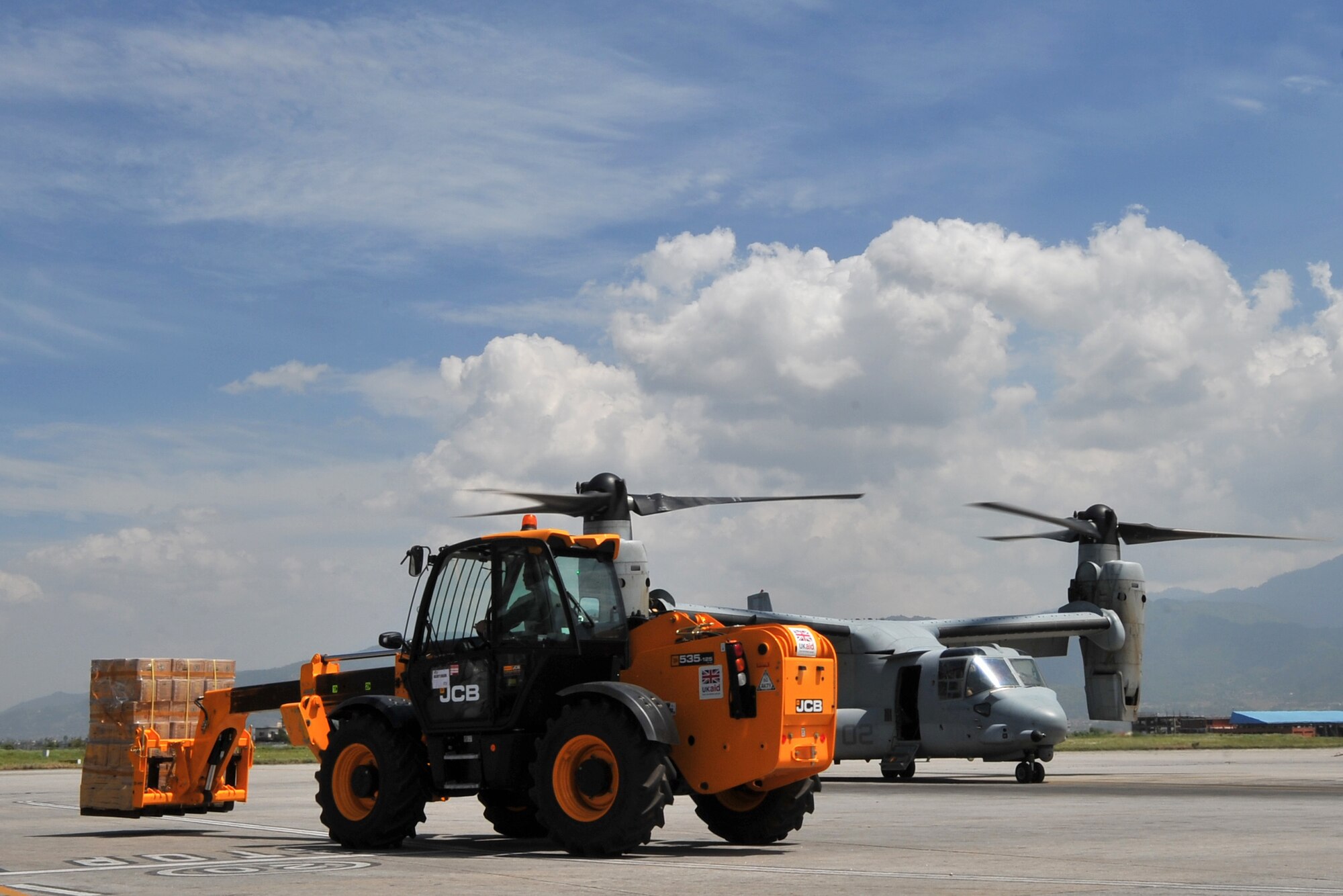U.S. Air Force Staff Sgt. Josh Foley, 36th Mobility Response Squadron aerial port supervisor, transports relief supplies with a forklift onto a U.S. Marine Corps MV-22 Osprey May 14, 2015, at Tribhuvan International Airport, Kathmandu, Nepal. The 36th Contingency Response Group Airmen are deployed to Nepal from Andersen Air Force Base, Guam, as part of Joint Task Force-505 to help the Government of Nepal and U.S. Agency for International Development with airfield operations and processing relief supplies after an earthquake devastated the country April 25, 2015. (U.S. Air Force photo by Staff Sgt. Melissa B. White/Released)