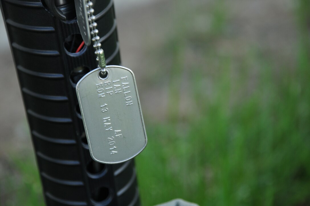 Dog tags hang from a memorial at Niagara Falls Air Reserve Station on May 13, 2015. The dog tags honor Tech. Sgt. Ian Fallon on the one-year anniversary of his death. (U.S. Air Force photo by Staff Sgt. Matthew Burke)