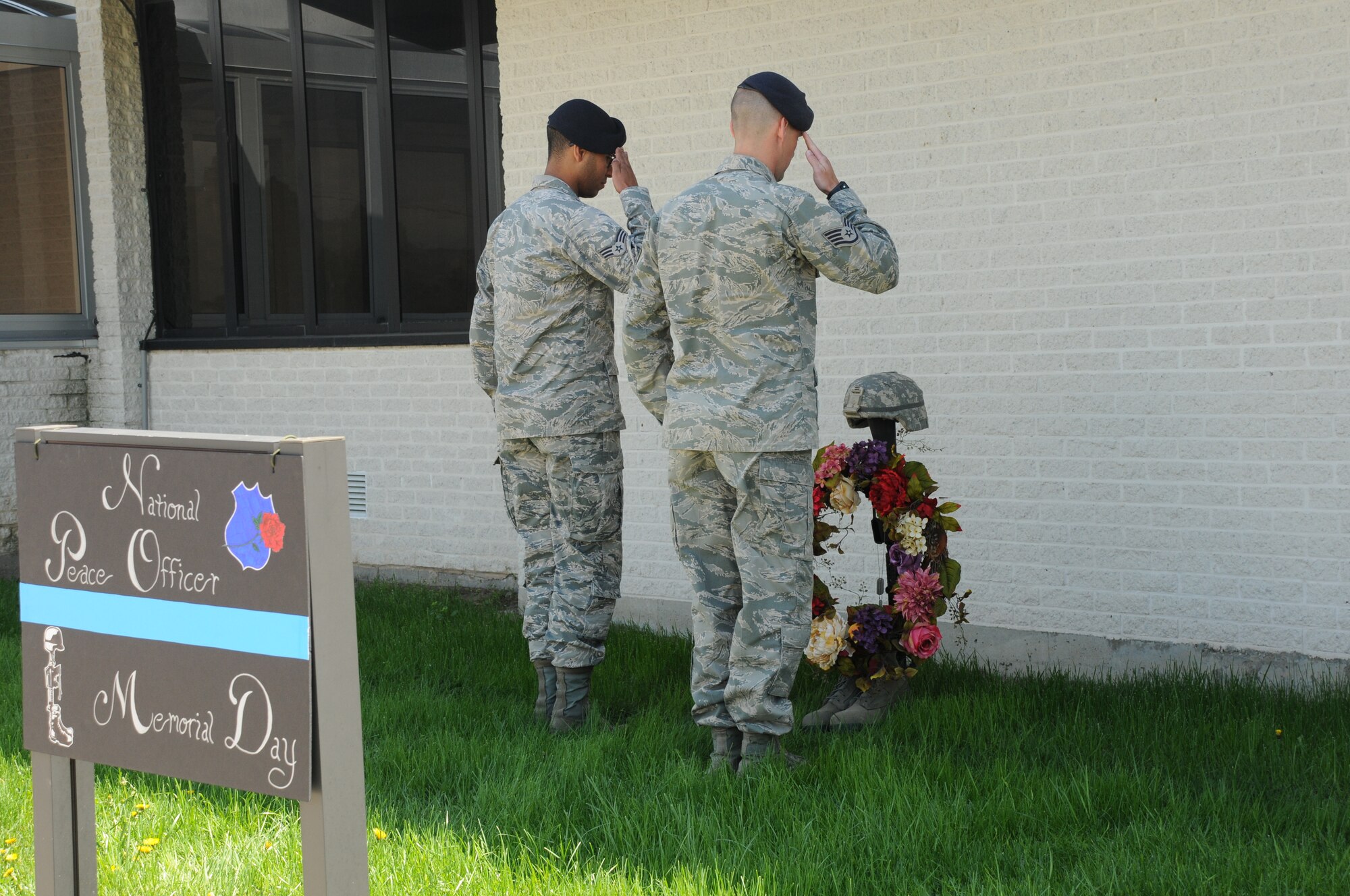 Members of the 914th Security Forces Squadron salute a memorial at the Niagara Falls Air Reserve Station on May 13, 2015. Personnel were honoring Tech. Sgt. Ian Fallon on the one-year anniversary of his death. (U.S. Air Force photo by Staff Sgt. Matthew Burke)
