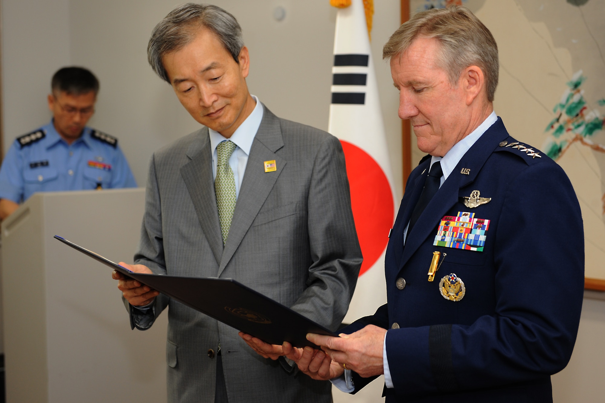 Gen. Hawk Carlisle, commander of Air Combat Command, and  Ahn Ho-Young, the Ambassador Extraordinary and Plenipotentiary of the Republic of Korea to the United States of America, read over the citation of the Order of National Security Merit Tongil Medal, which was presented to Carlisle at the Embassy of the Republic of Korea in Washington, D.C. May 12, 2015. Carlisle was awarded for his service in promoting military cooperation between the Republic of Korea and the United States. (U.S. Air Force photo by Tech. Sgt. Dan DeCook/Released)