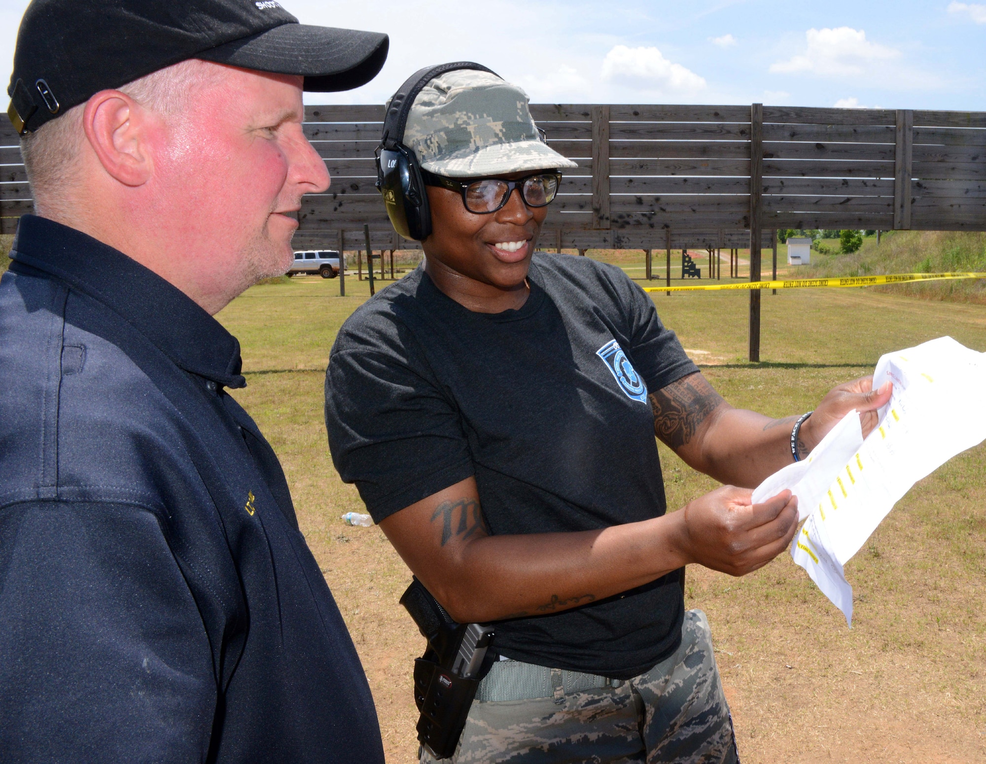 Lt. David Hill, Perry Police Department, reviews a score sheet ,May 14, 2015, with Staff Sgt. Ladonna Winston, 78th Security Forces Squadron, during a shoot-out competition at the Perry Firing Range. The competition was one of several events celebrating National Police Week. (U.S. Air Force photo by Tommie Horton)