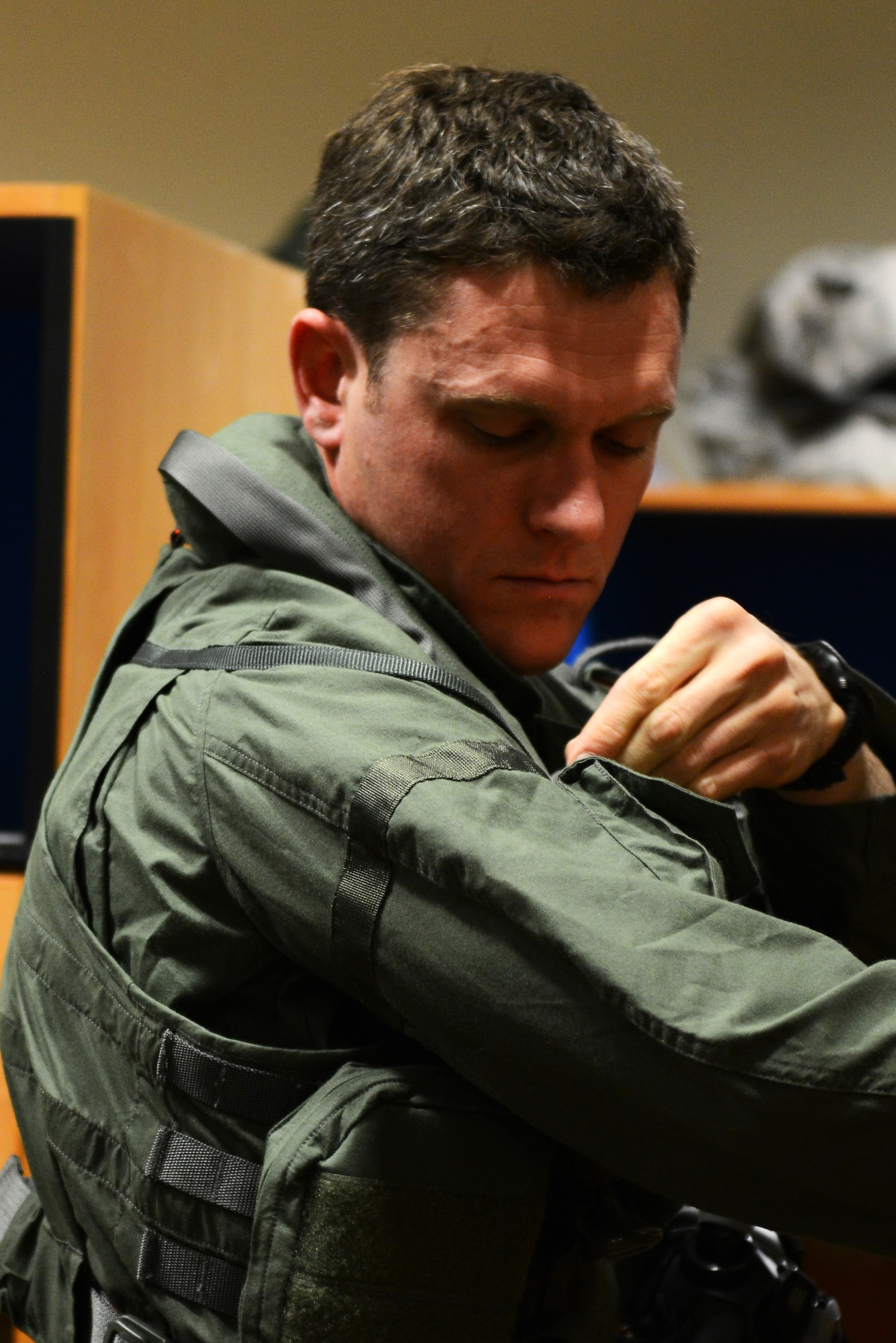 Royal Australian Air Force Maj. Andrew Jackson, 61st Fighter Squadron RAAF squadron leader, straps on a gravitational force suit prior to a flight at Luke Air Force Base, Arizona, May 14, 2015. Jackson was preparing to fly the first RAAF F-35 A Lightning II flight at Luke. (U.S. Air Force photo by Senior Airman James Hensley)  