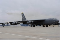 A B-52H bomber takes flight while a second Stratofortress taxis toward takeoff during a Constant Vigilance rapid launch exercise at Minot Air Force Base, N.D., May 13, 2015. The fly-off event concluded the one-week exercise, which tested Air Force Global Strike Command’s combat readiness and its ability to provide nuclear deterrence and long-range strike capabilities to the President and combatant commanders on short notice. (U.S. Air Force photo/Senior Airman Kristoffer Kaubisch)